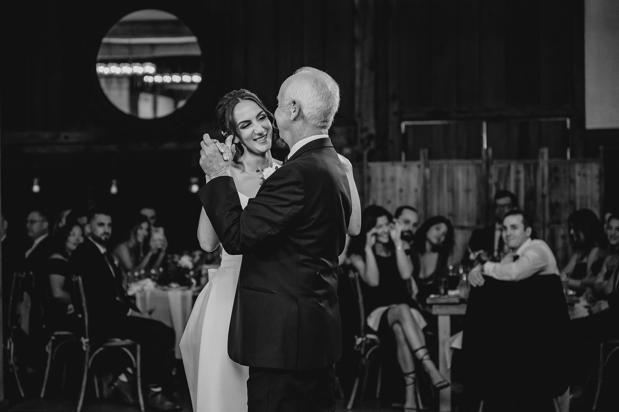 bride grins at father during dance at NJ wedding reception 