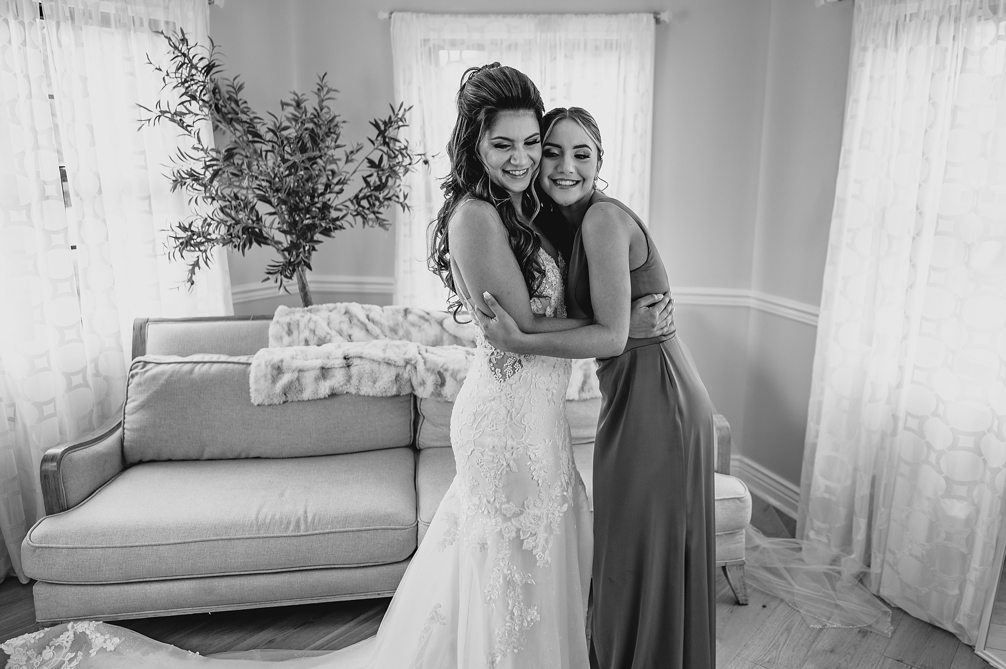 woman hugs bride during prep for Skyview Golf Club wedding day