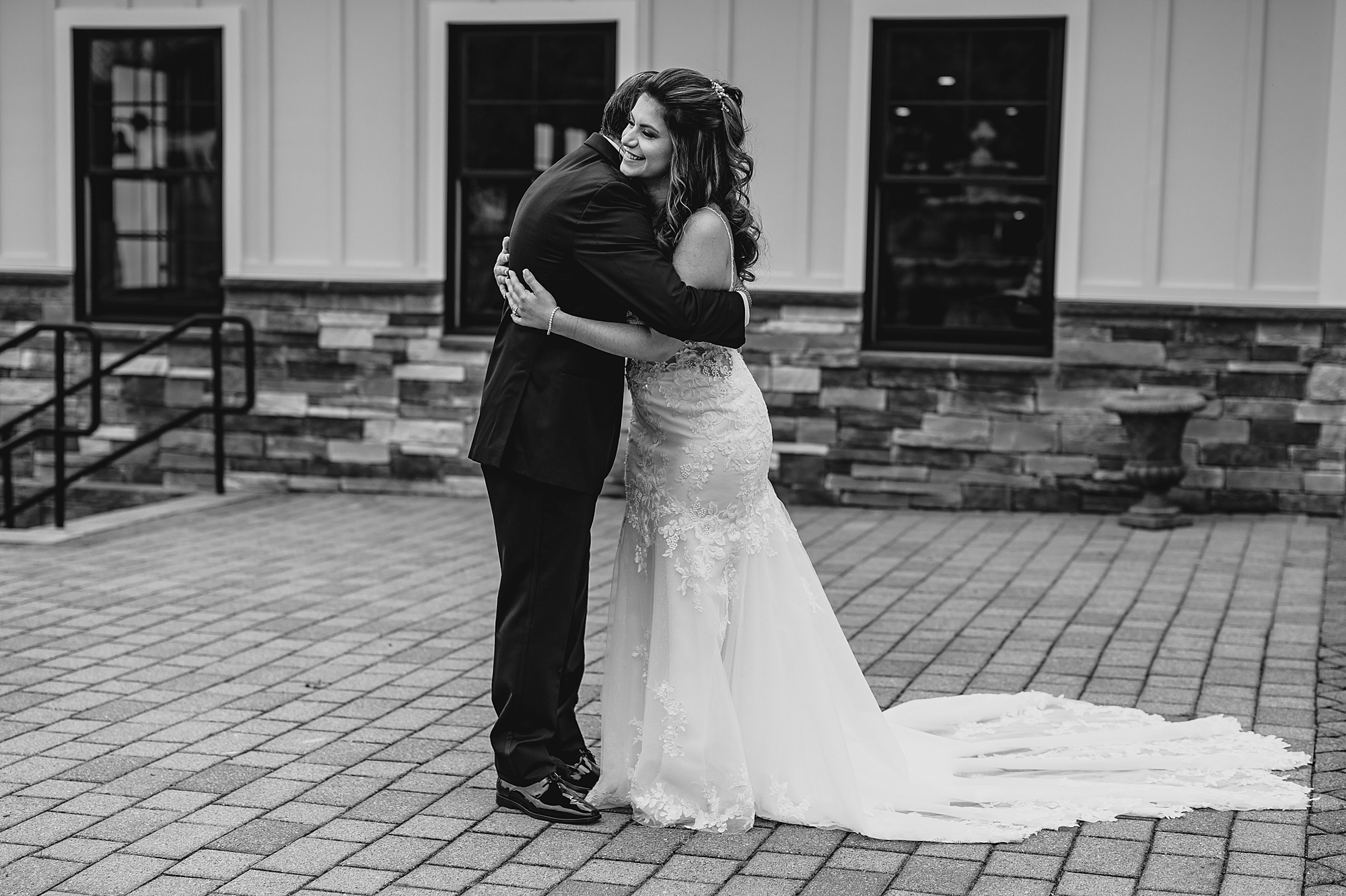 bride hugs father during first look on patio at Skyview Golf Club