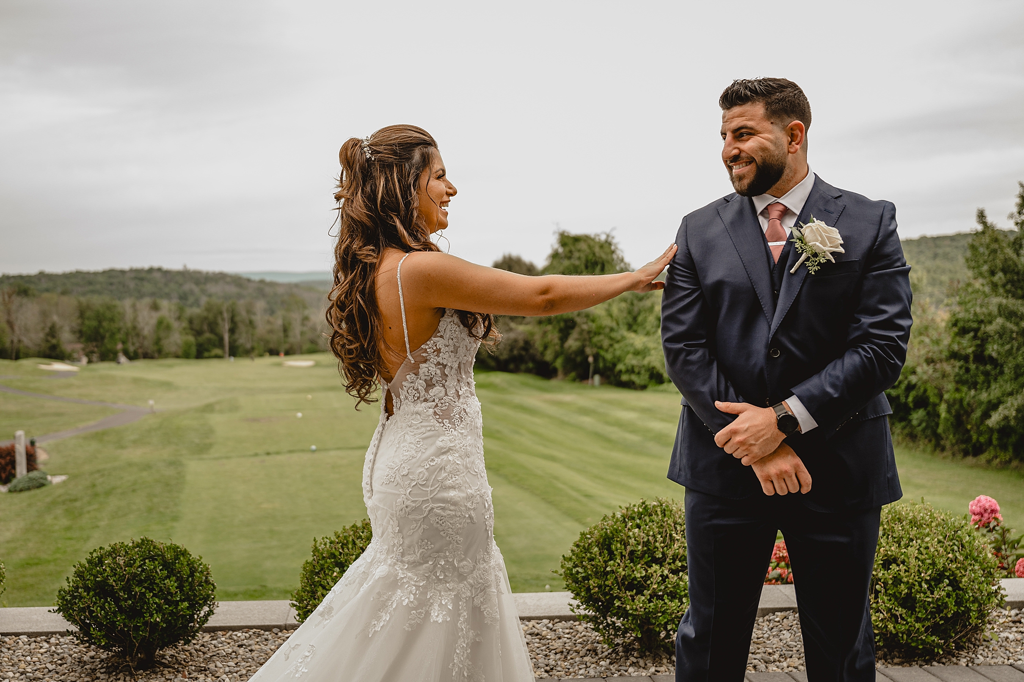 groom turns to look at bride during first look at Skyview Golf Club