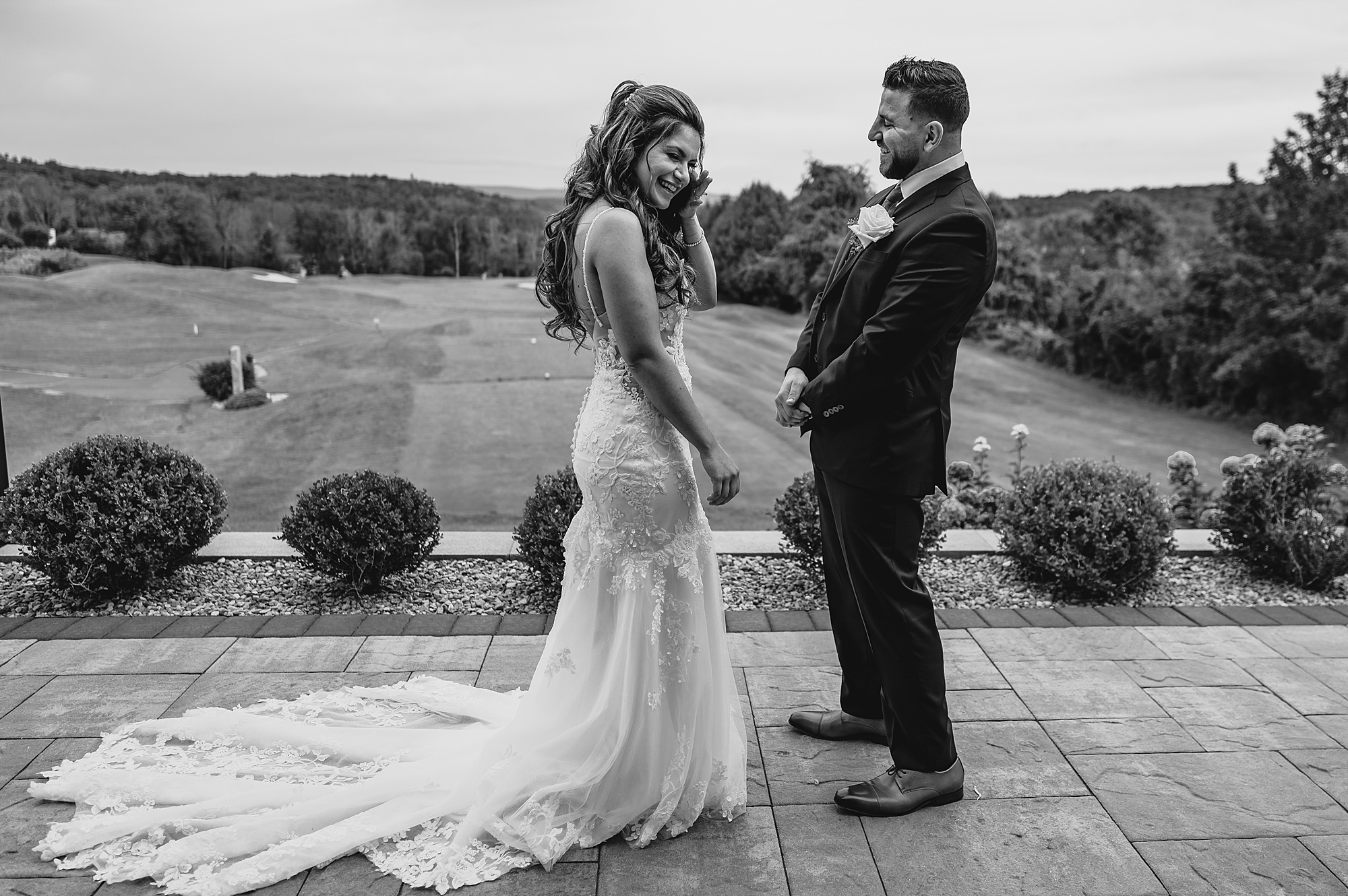 bride and groom laugh together during first look on patio Skyview Golf Club