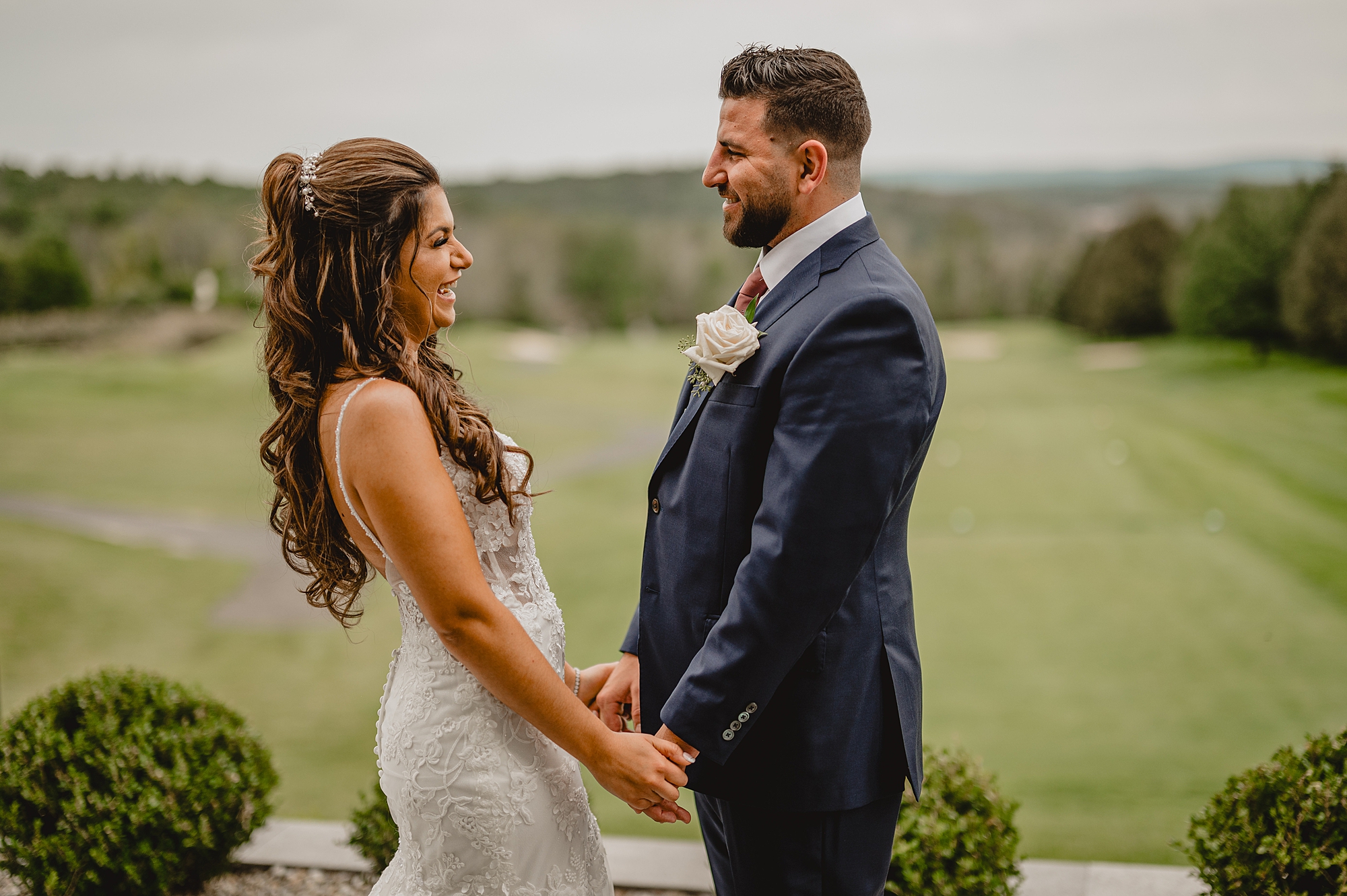 bride and groom smile holding hands during Sparta NJ wedding day