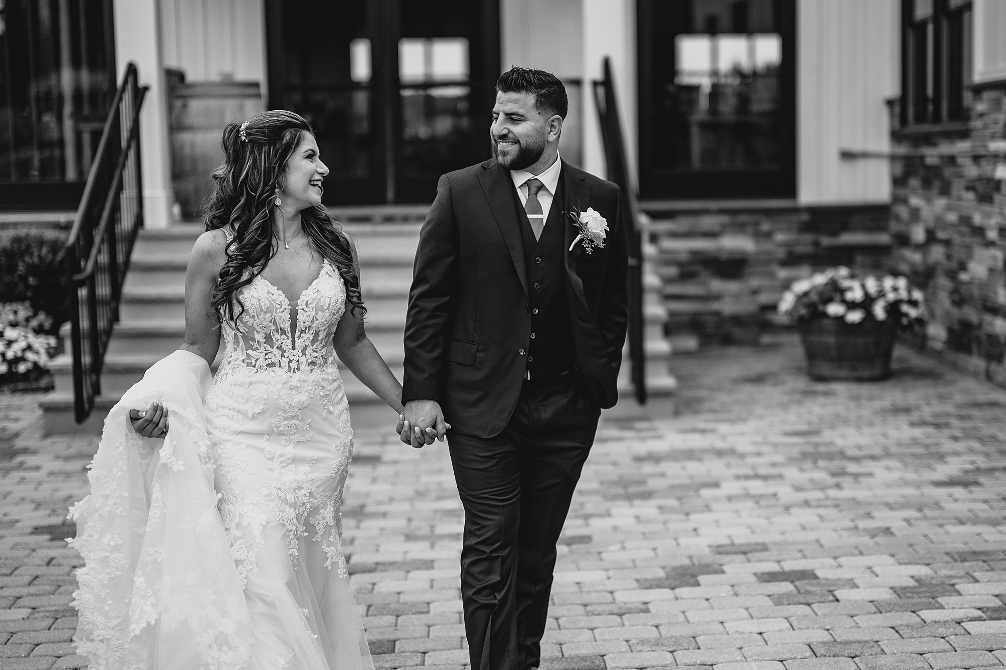 newlyweds hold hands walking on patio at Skyview Golf Club