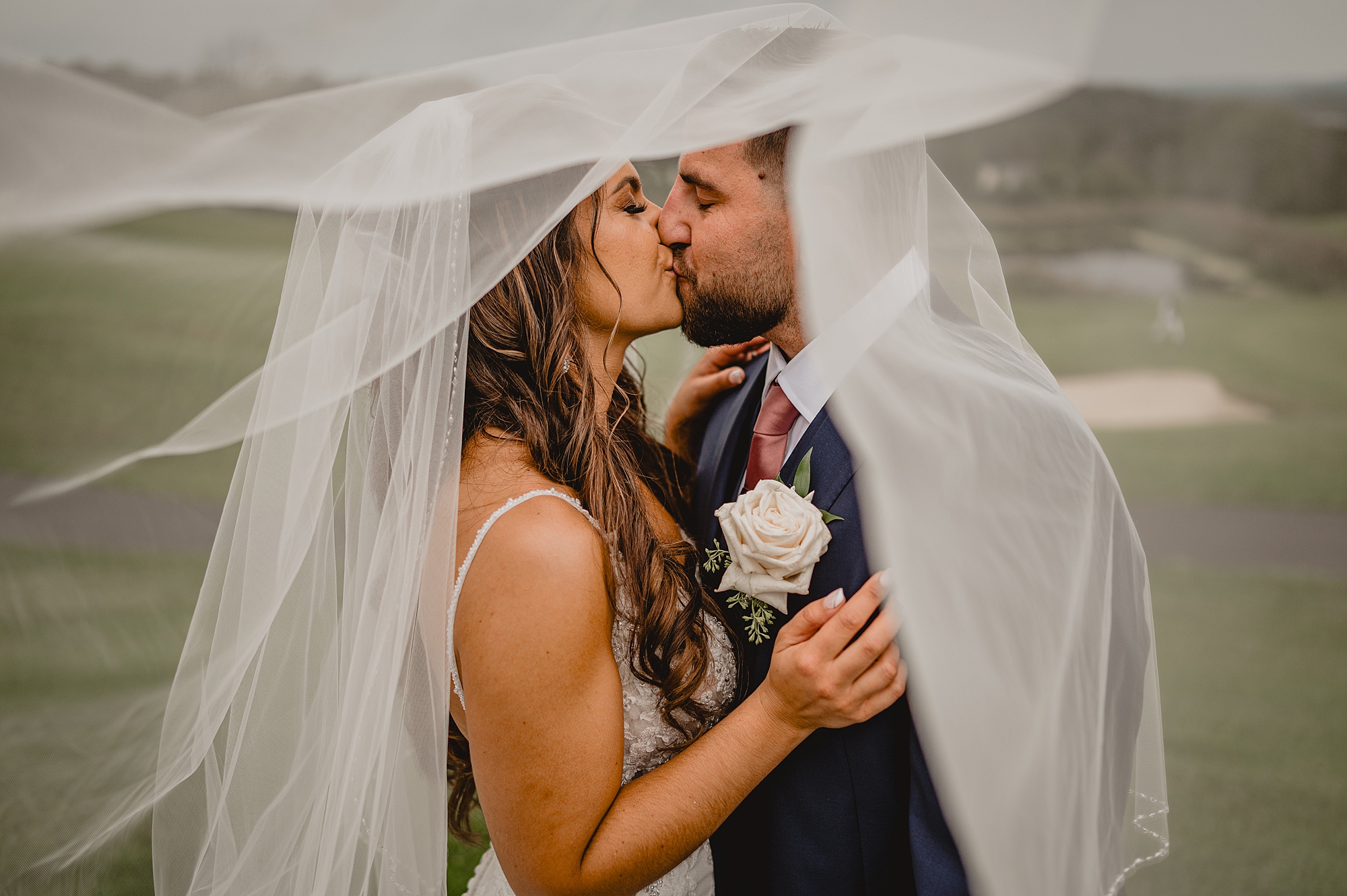 newlyweds kiss under bride's veil