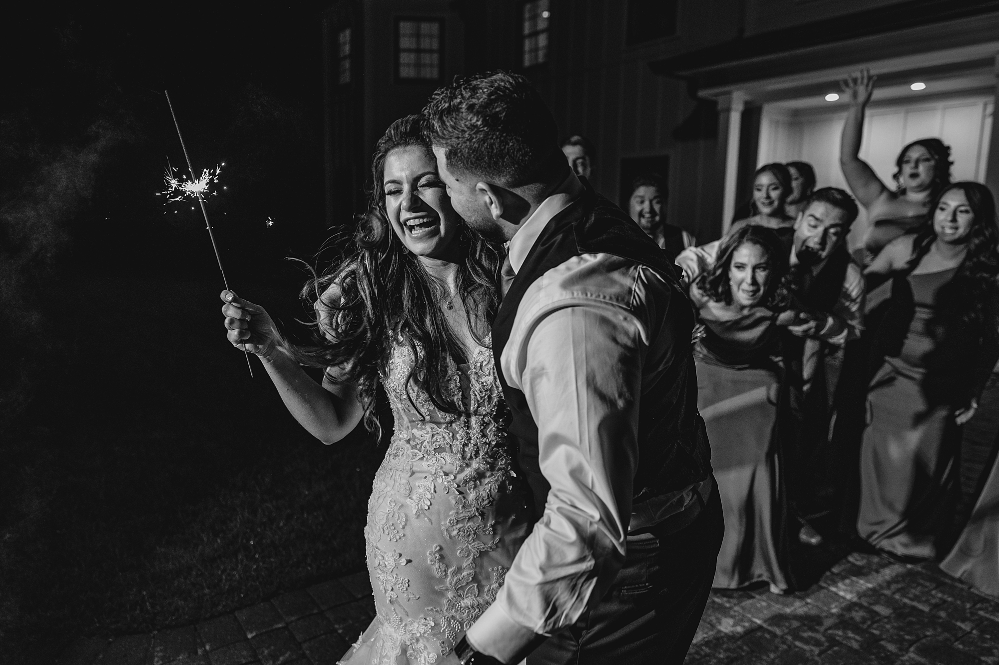 groom kisses bride will they hold sparklers during exit at Skyview Golf Club
