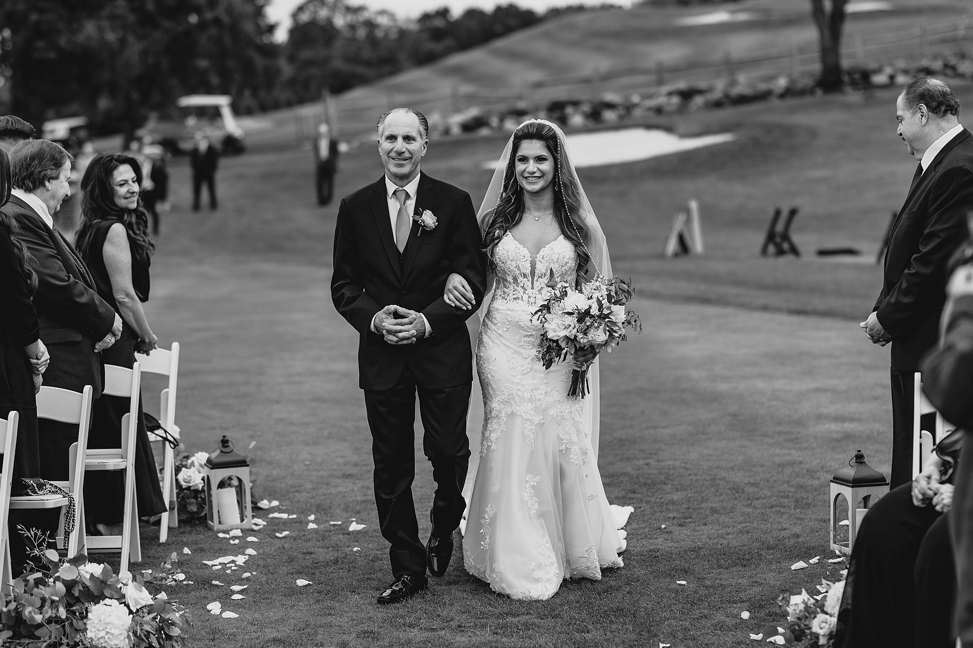father escorts bride down aisle during ceremony on lawn at Skyview Golf Club
