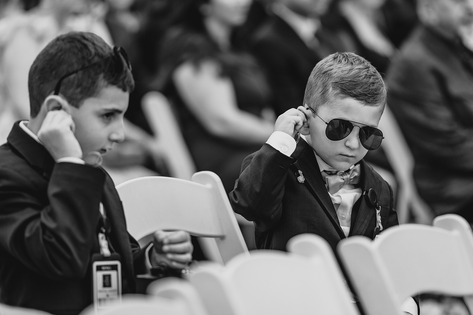 boy in aviators listens during ceremony
