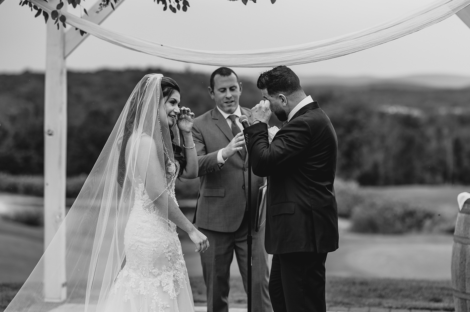 groom cries during ceremony on lawn at Skyview Golf Club