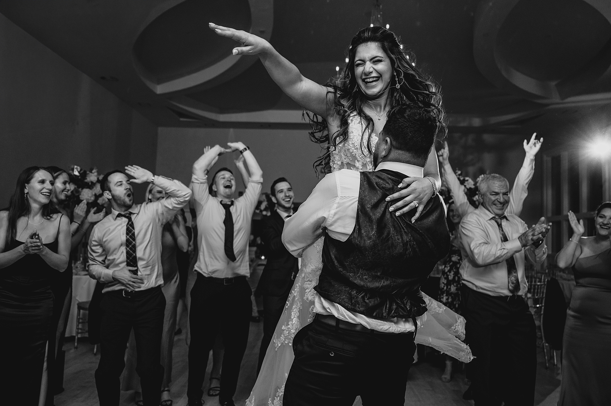 groom lifts up bride during Sparta NJ wedding reception on dance floor