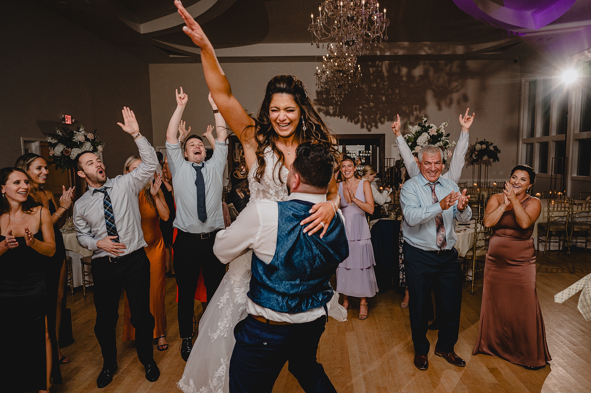 groom lifts up bride during Sparta NJ wedding reception on dance floor
