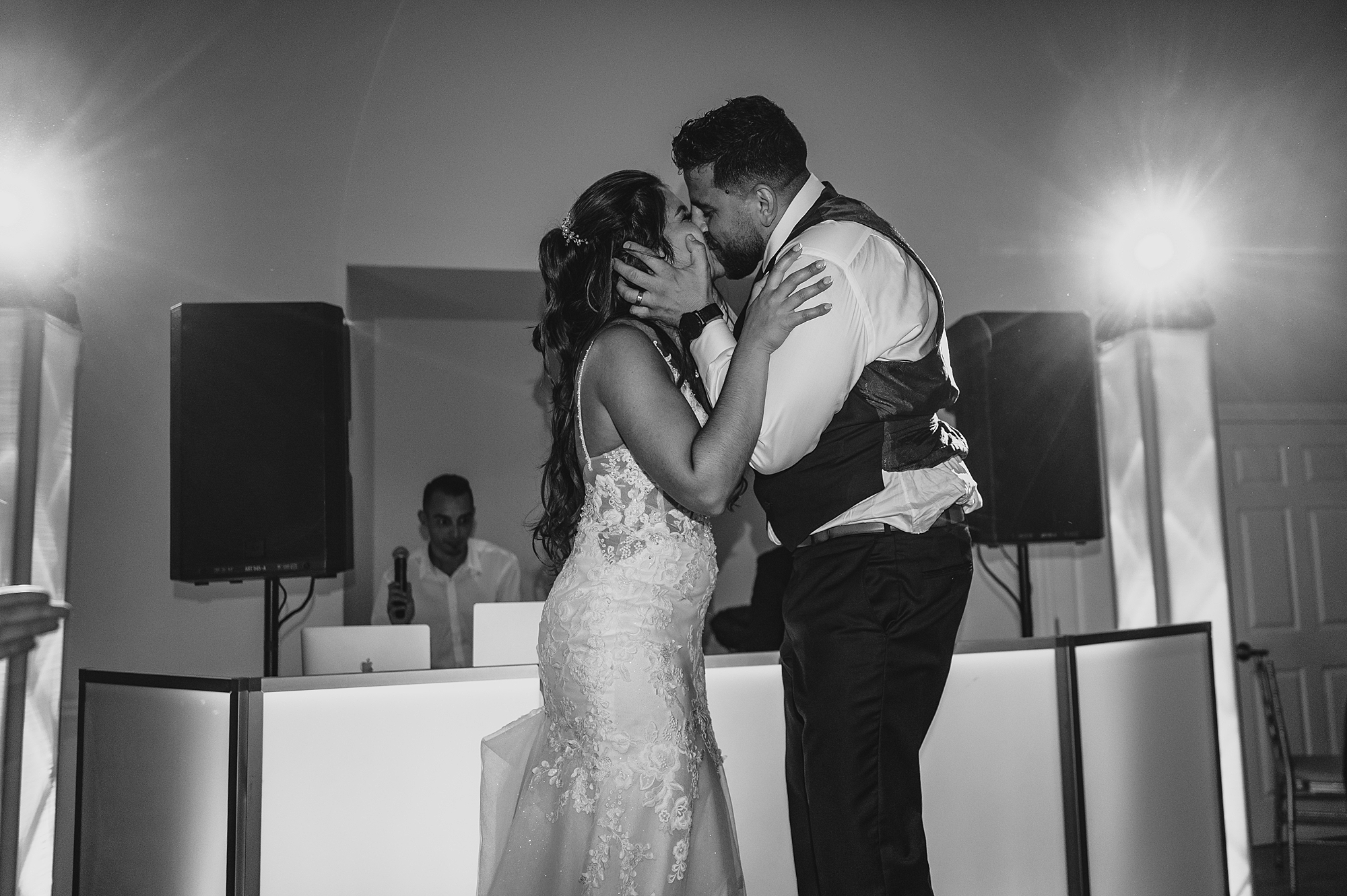 newlyweds kiss in front of DJ stand at Skyview Golf Club