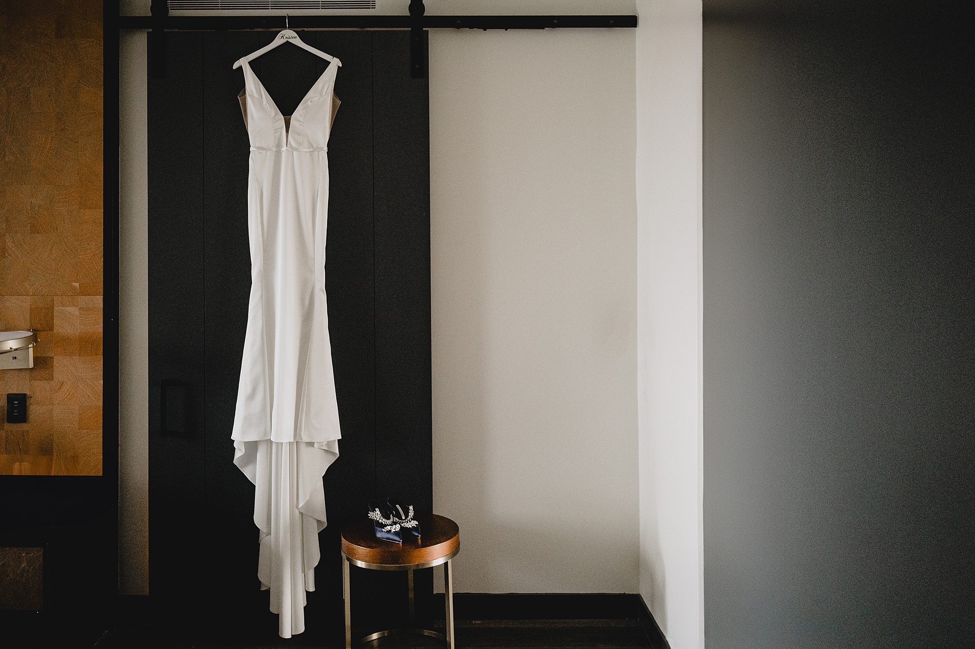 chic stylish wedding dress hangs in hotel room in Jersey City