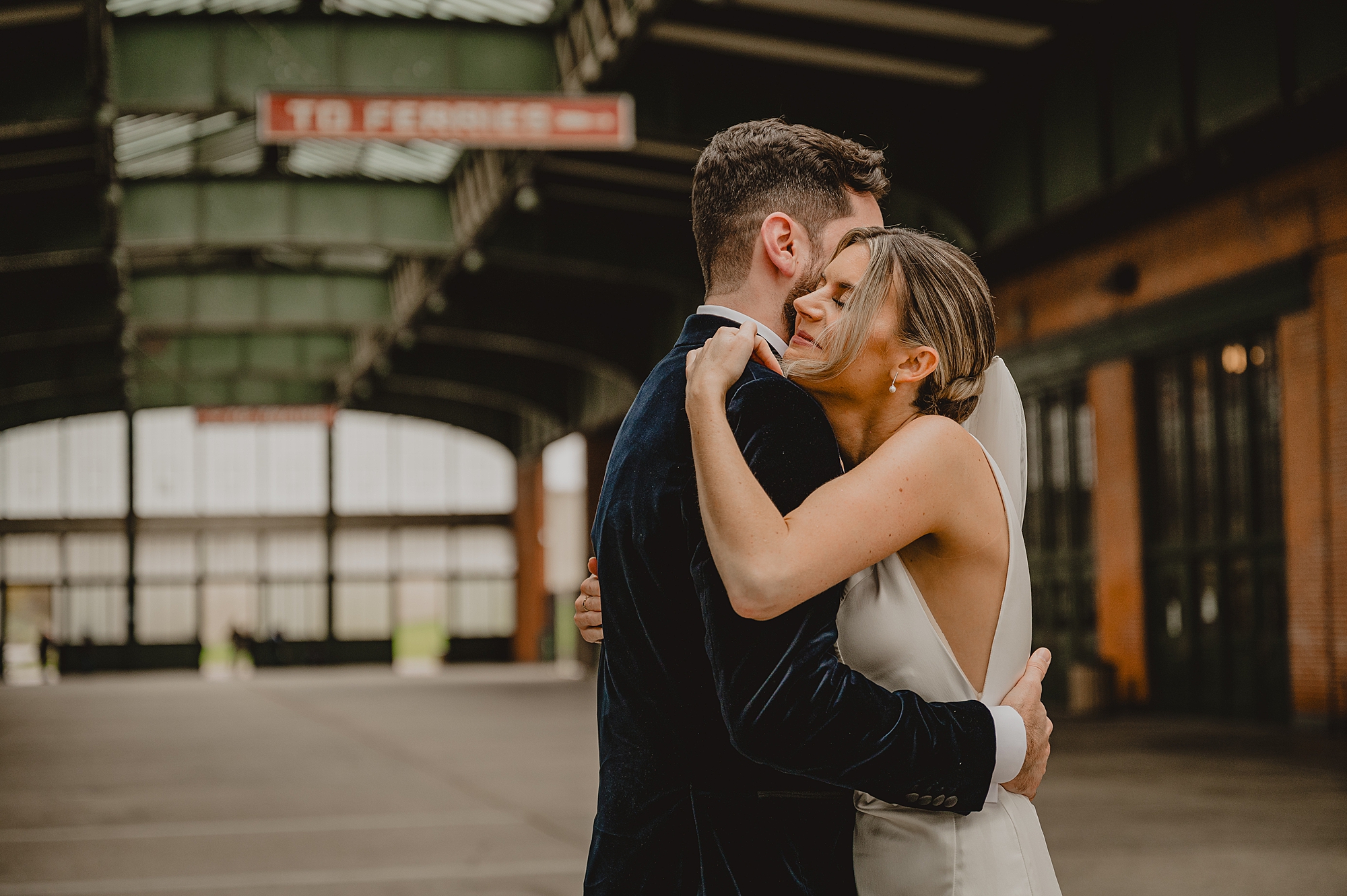 bride hugs groom inside Maritime Parc in Jersey City