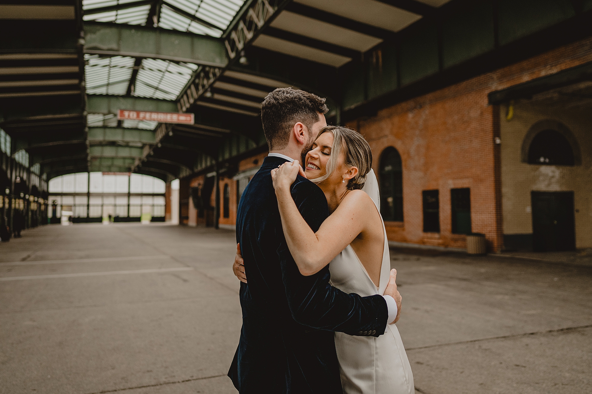 bride hugs groom in velvet jacket during NJ wedding day