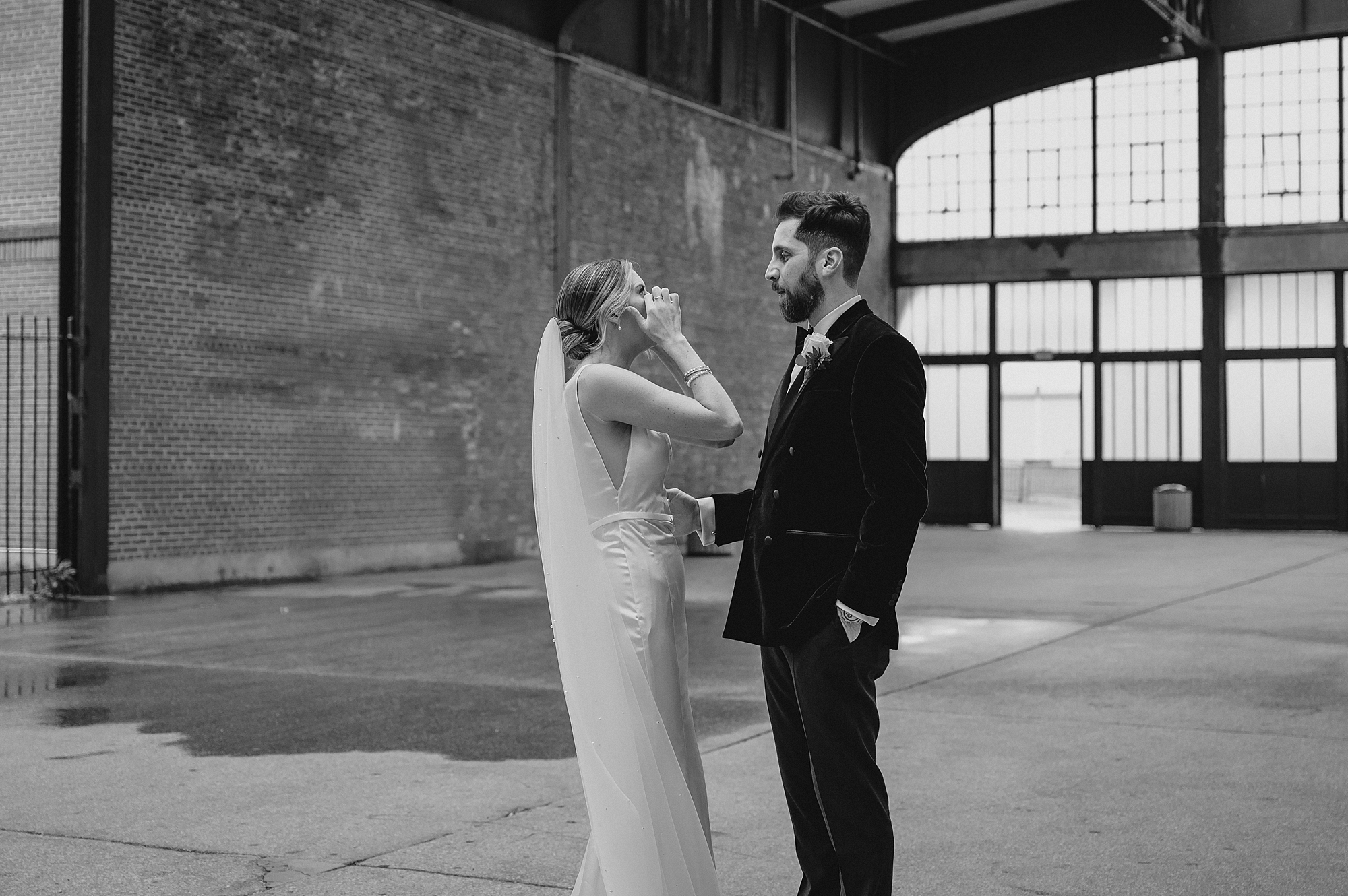 bride wipes away tears during Maritime Parc wedding portraits