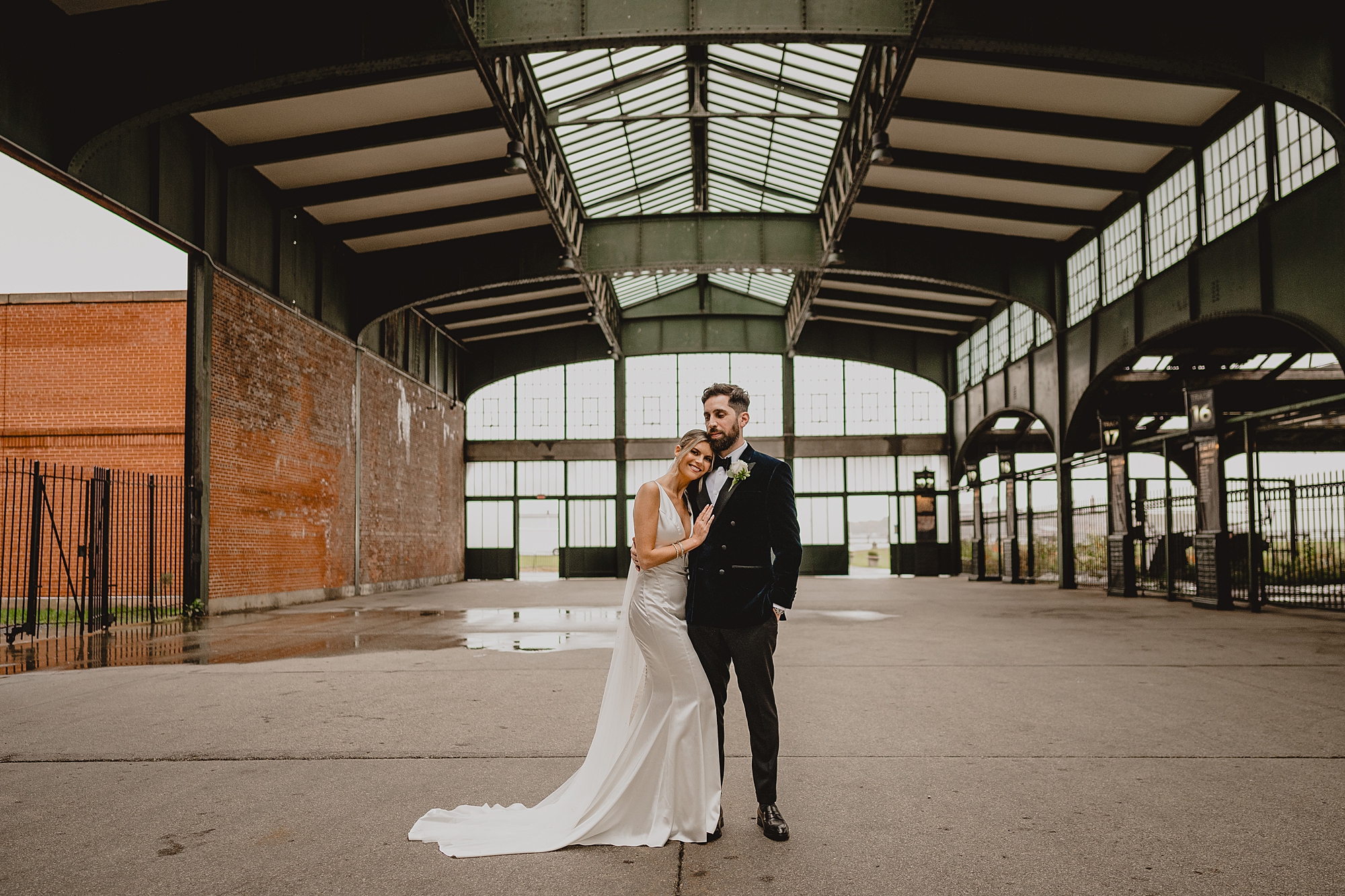 newlyweds hug inside hanger of Maritime Parc
