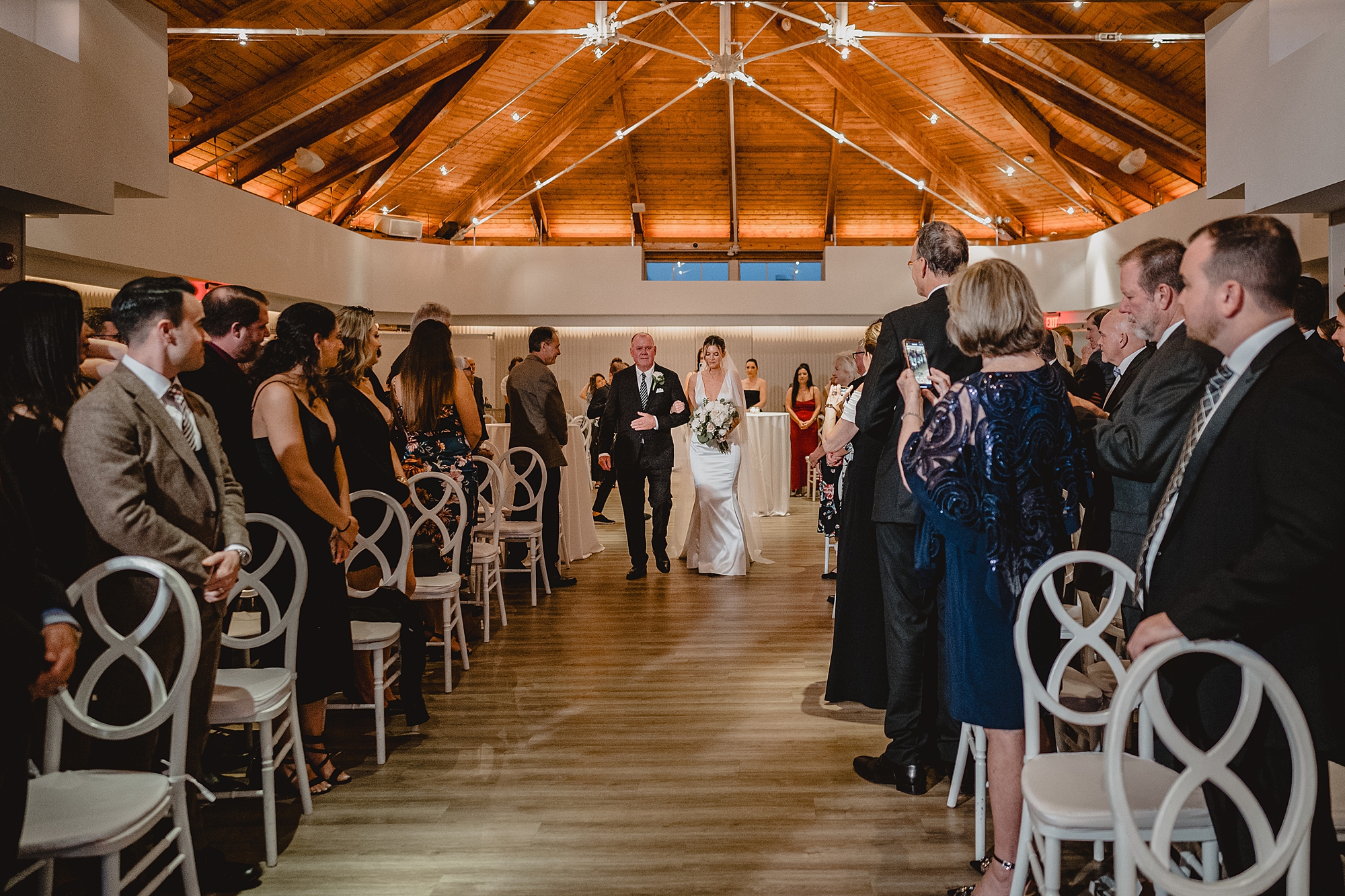 bride enters wedding ceremony escorted by father at Maritime Parc