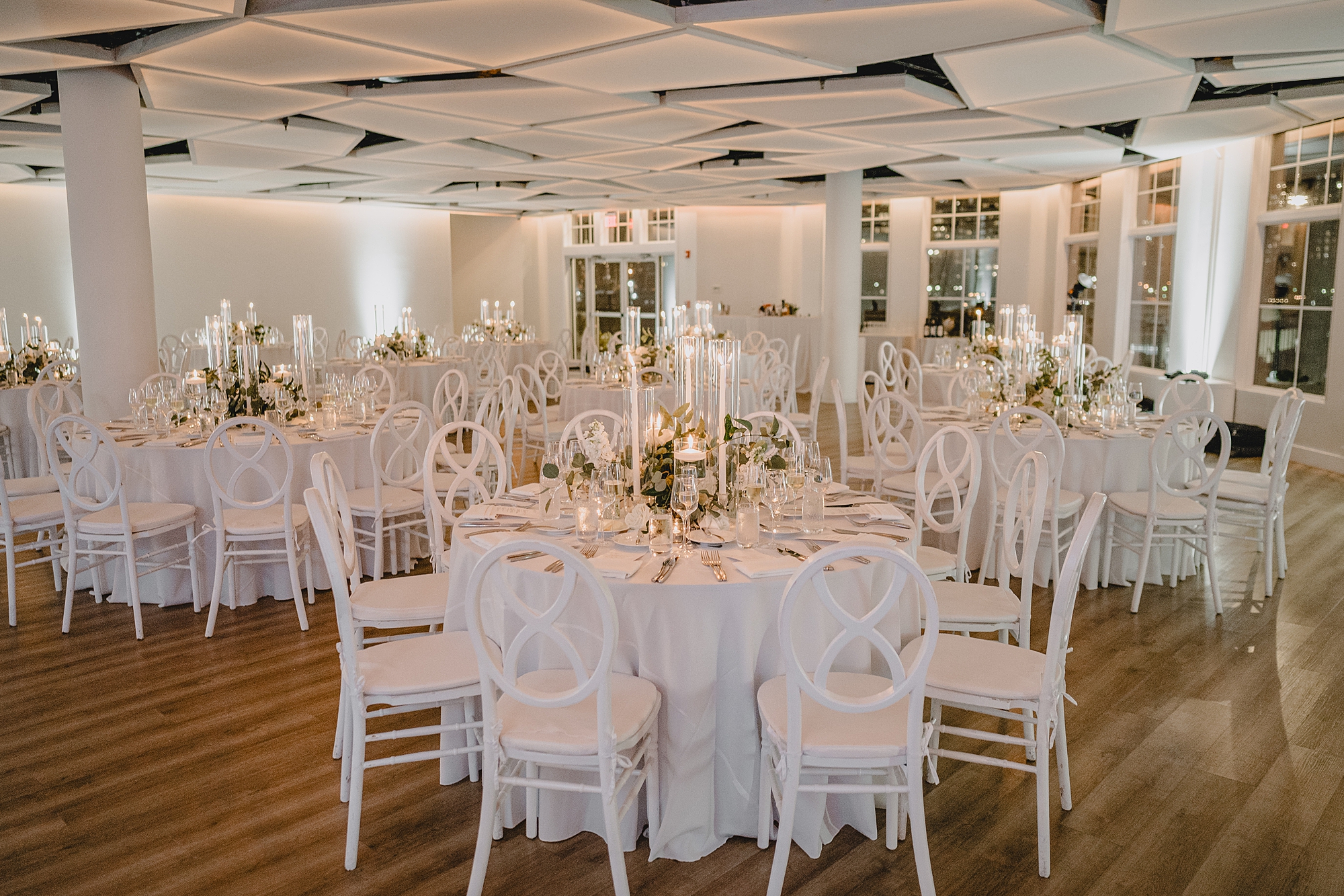 Maritime Parc wedding reception with white taper candles and white chairs