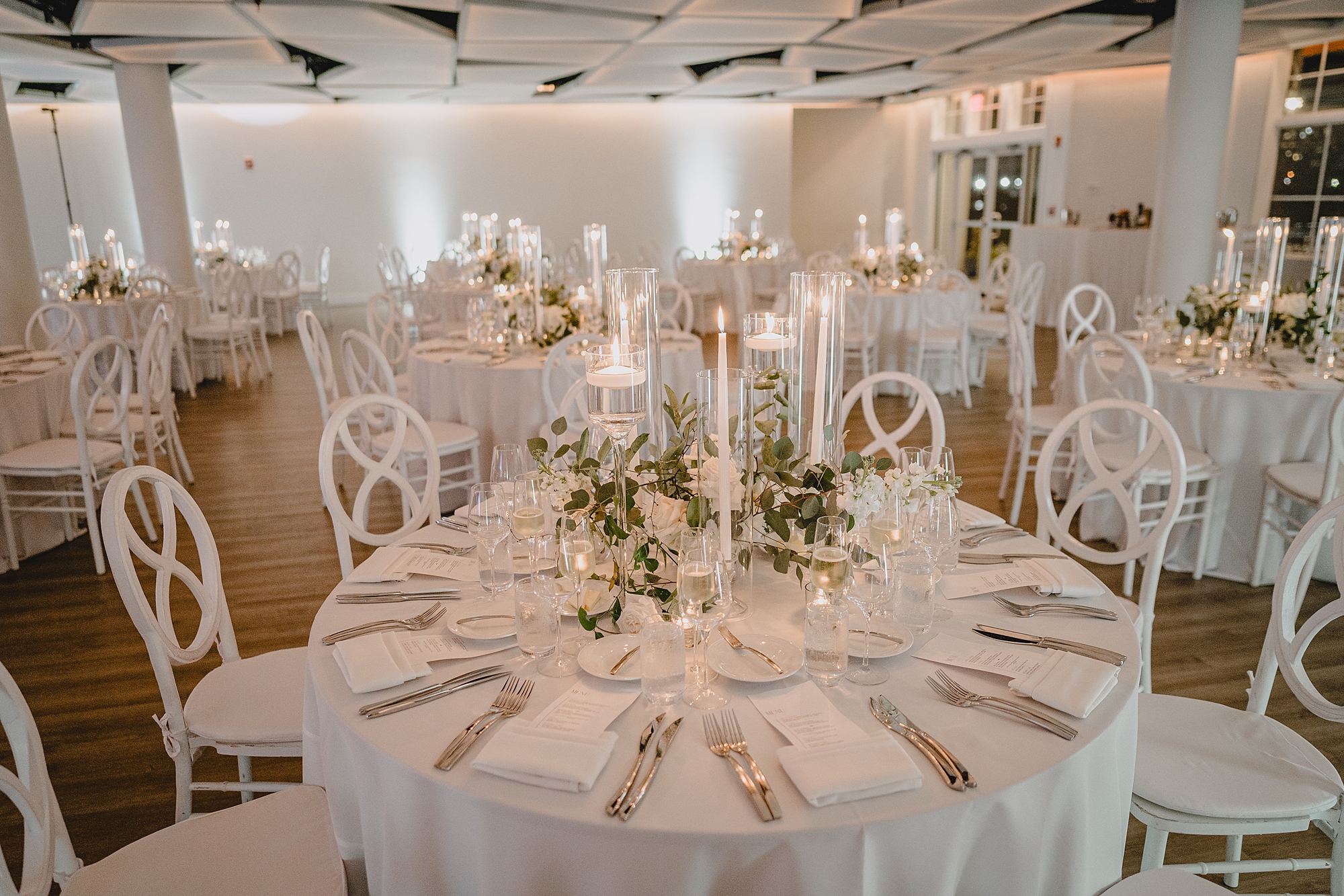 wedding reception with white candles and greenery centerpieces at Maritime Parc