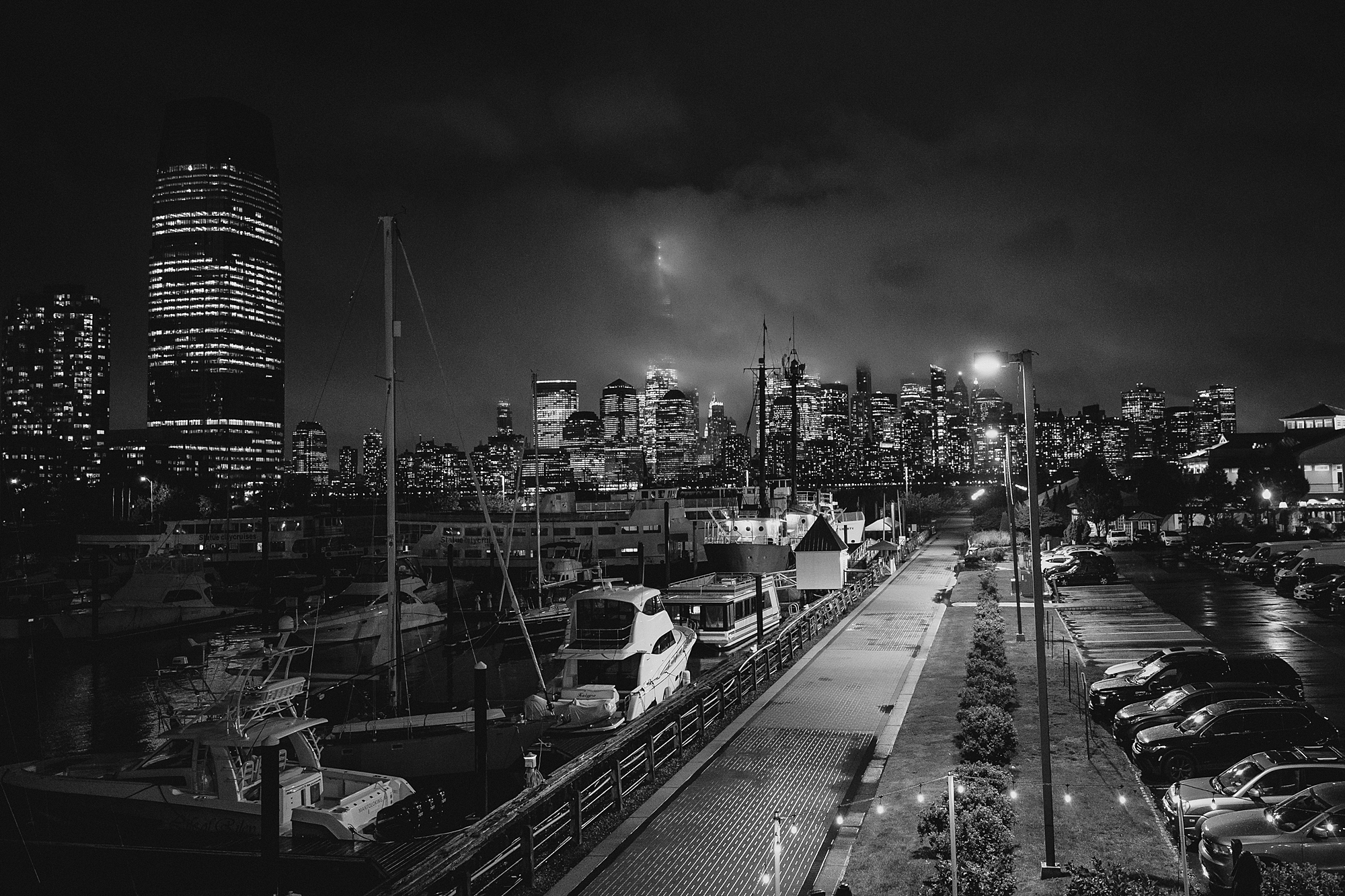 view of Jersey City and marina at night from Maritime Parc