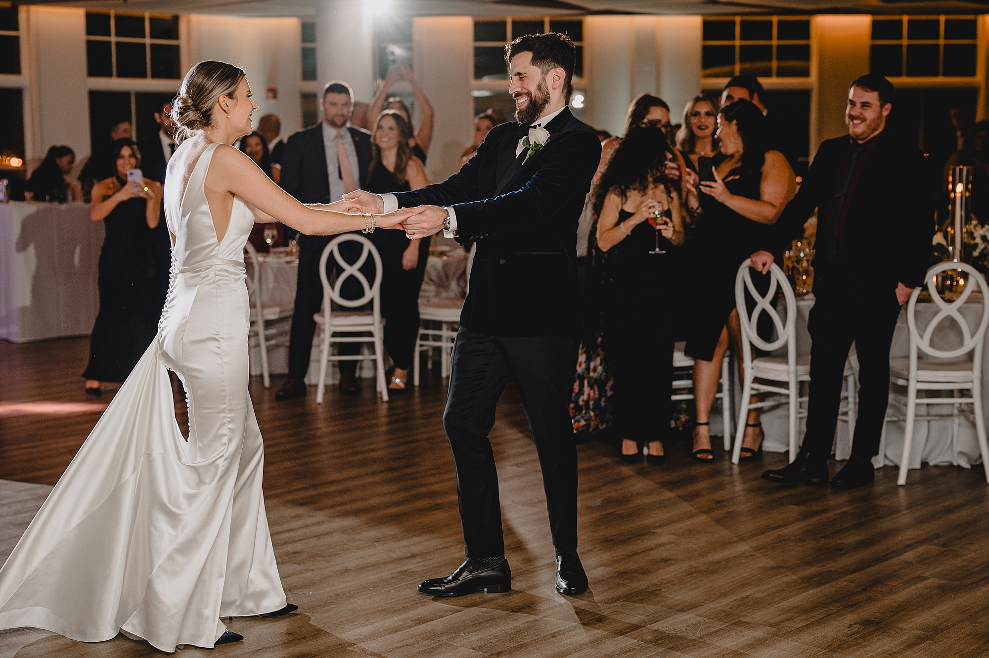 groom twirls bride around on dance floor at Maritime Parc