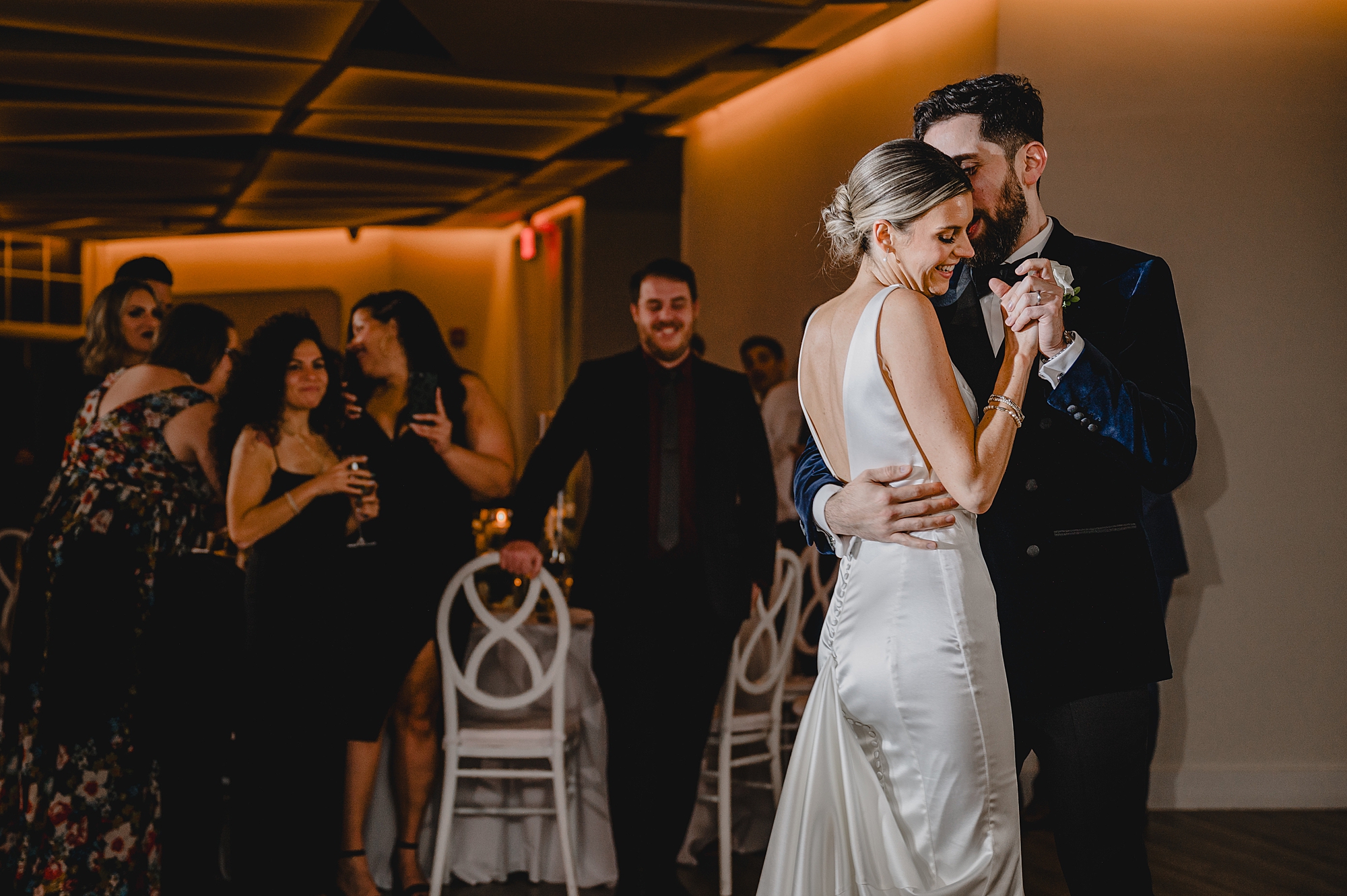 groom hugs bride to him during first dance at Maritime Parc