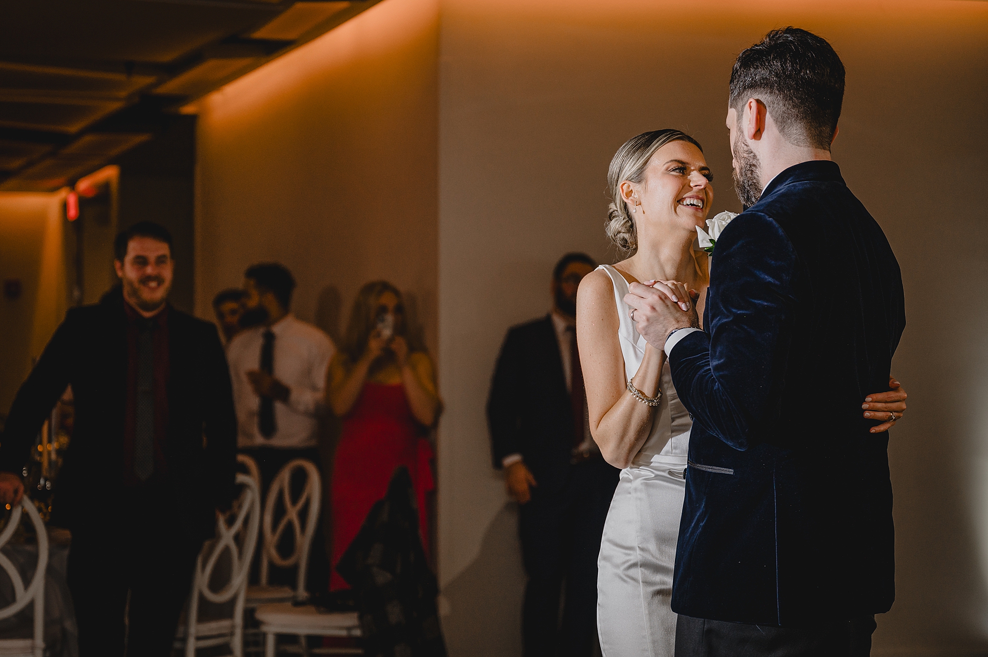 groom hugs bride to him during first dance at Maritime Parc