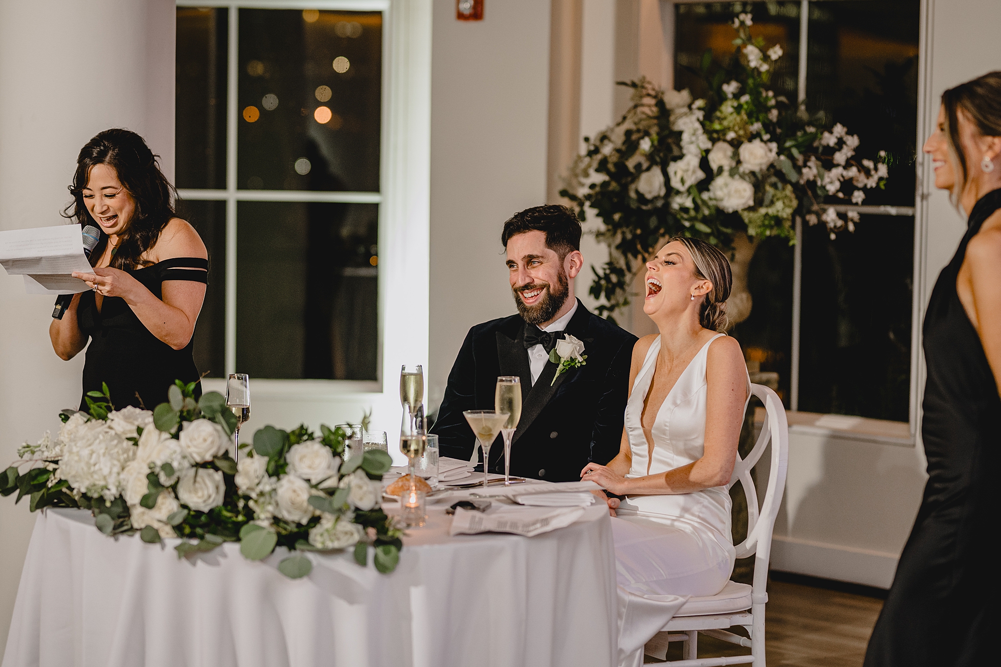 bride and groom laugh during toasts at NJ wedding reception
