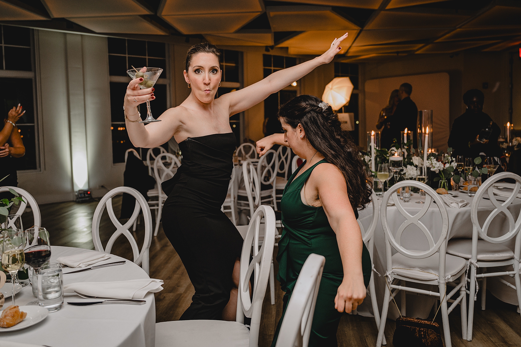 bridesmaid dances holding up martini glass