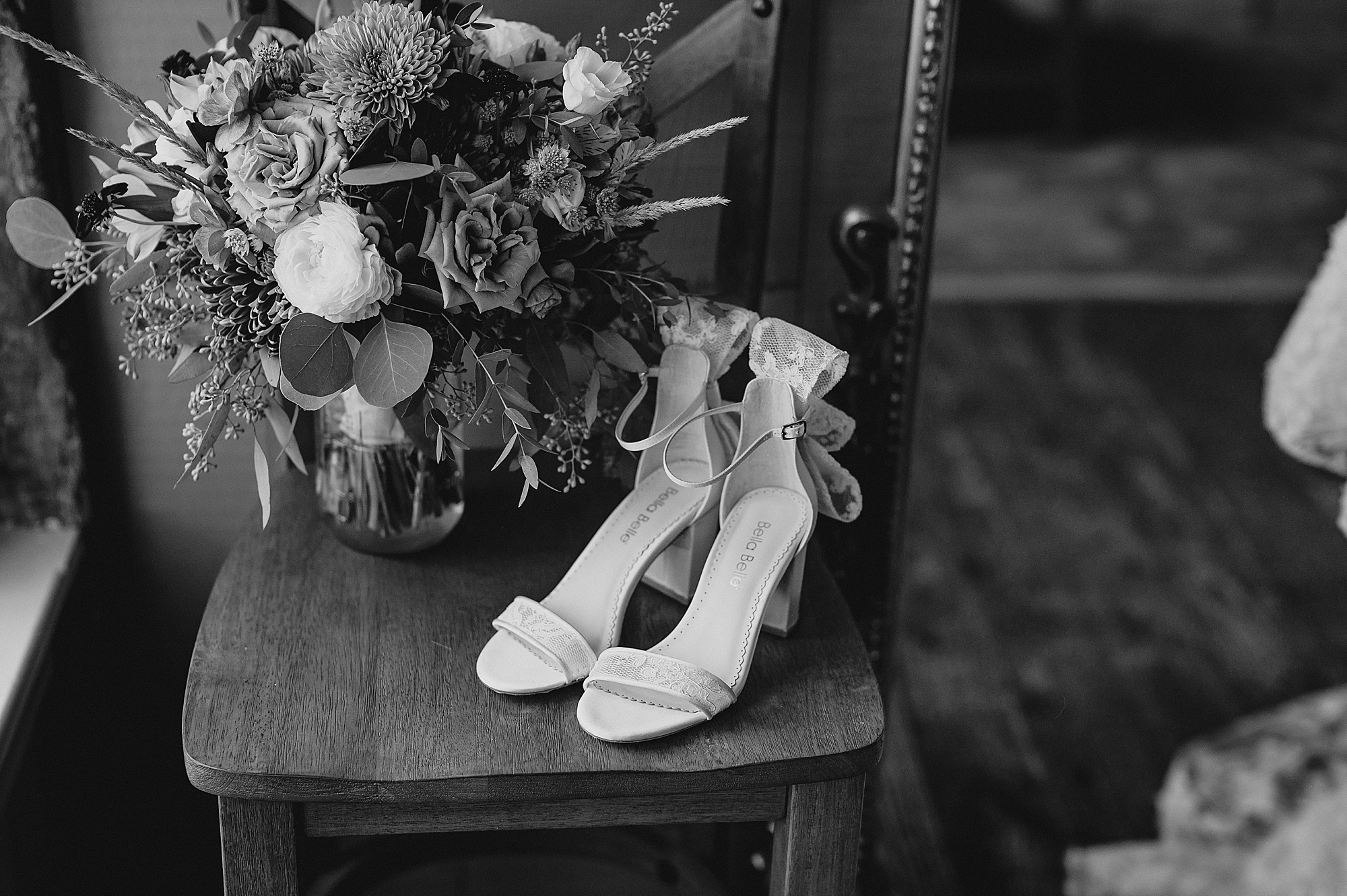 bride's shoes and bouquet sit on wooden chair at Crossed Keys Estate