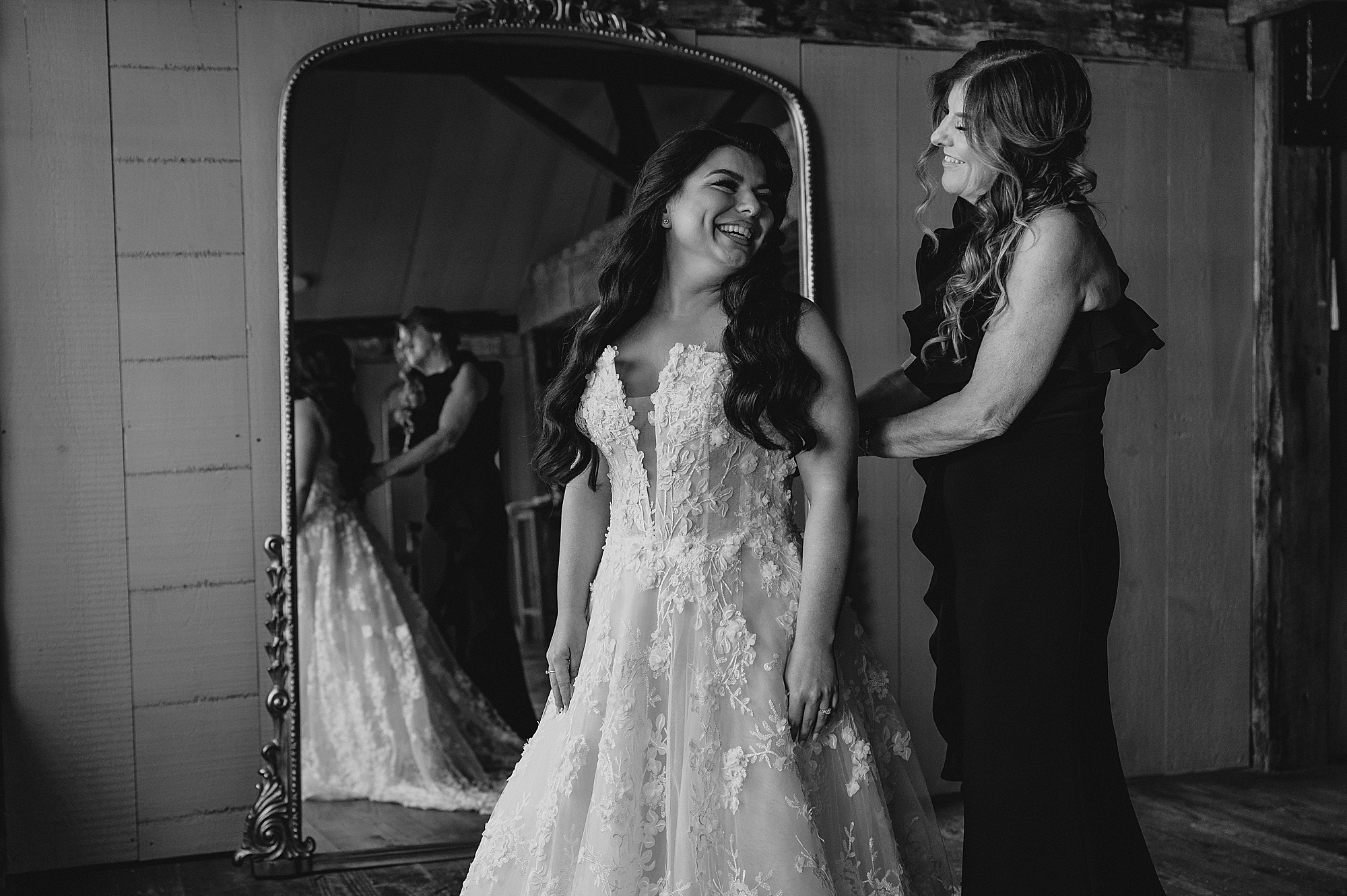 bridesmaid helps bride into wedding dress on morning of wedding