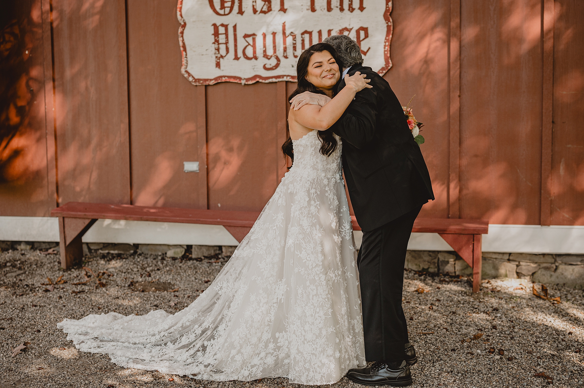 bride and dad hug during first look on wedding day in front of Grist Mill at Crossed Keys Estate