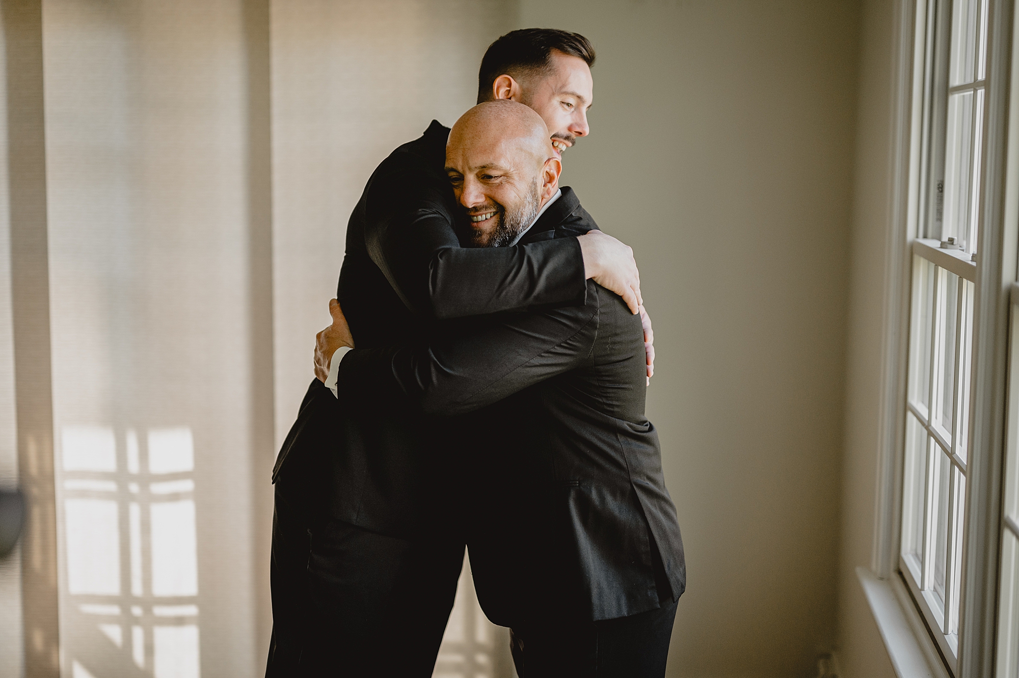 groom and groomsmen hug during prep in New Jersey