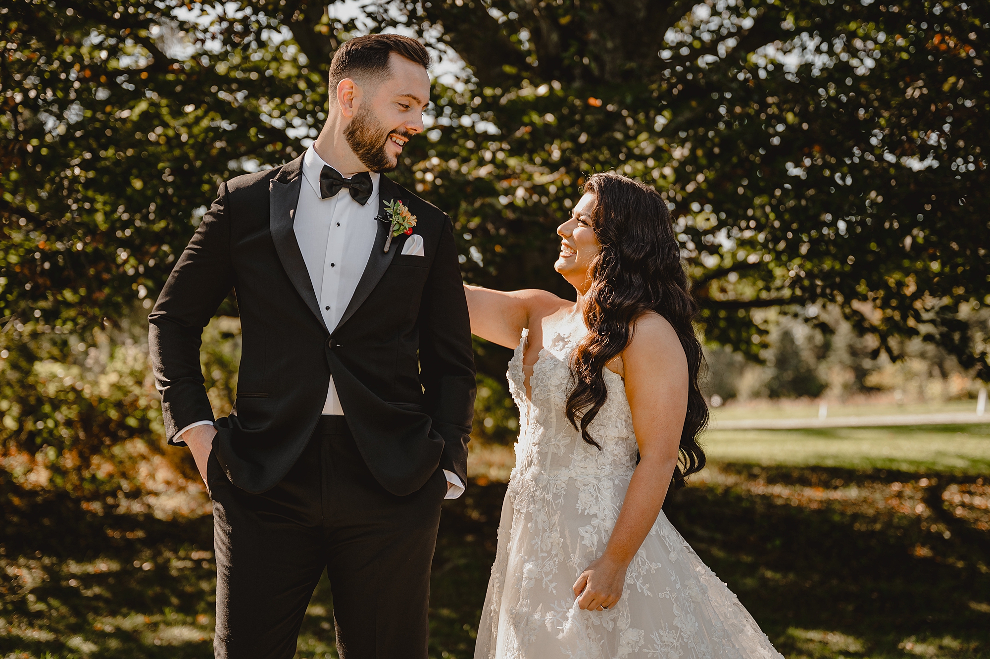bride taps groom on back during first look bridge at Crossed Keys Estate