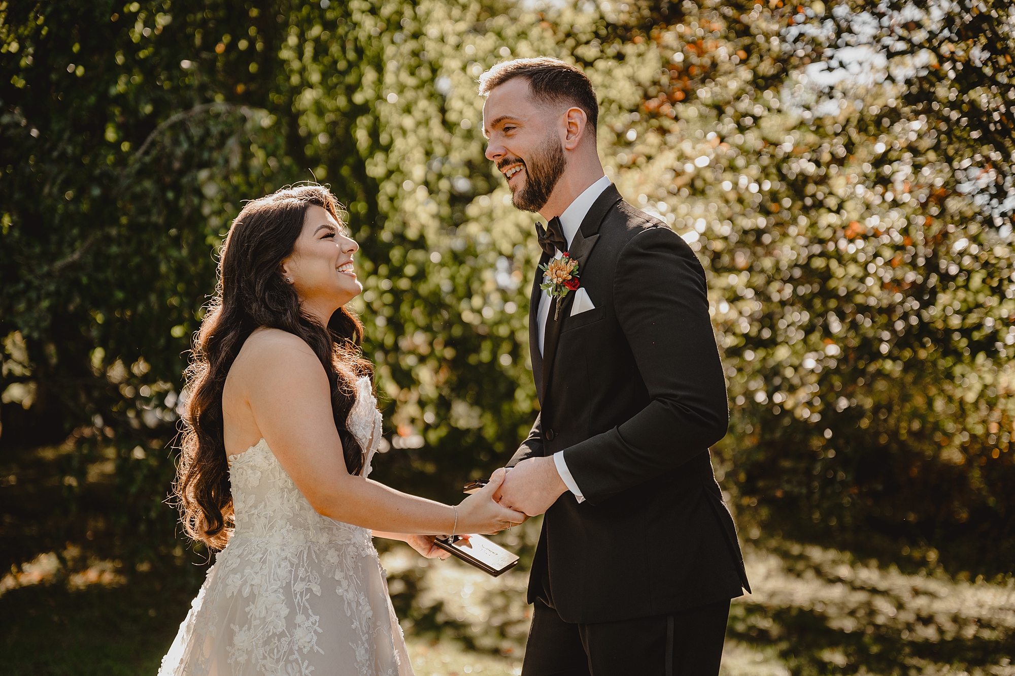 bride and groom laugh during first look at Crossed Keys Estate