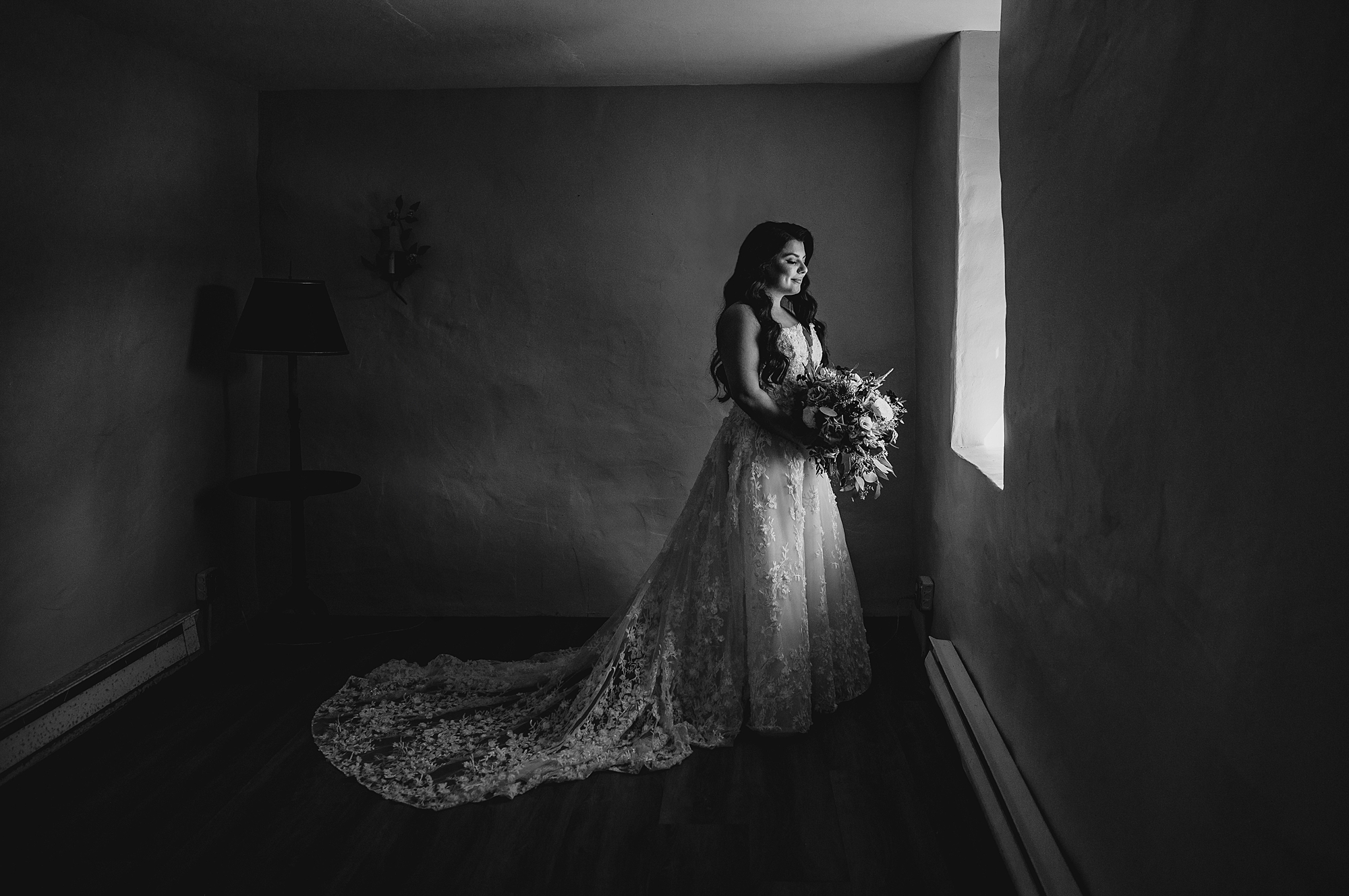 bride looks out window inside Crossed Keys Estate