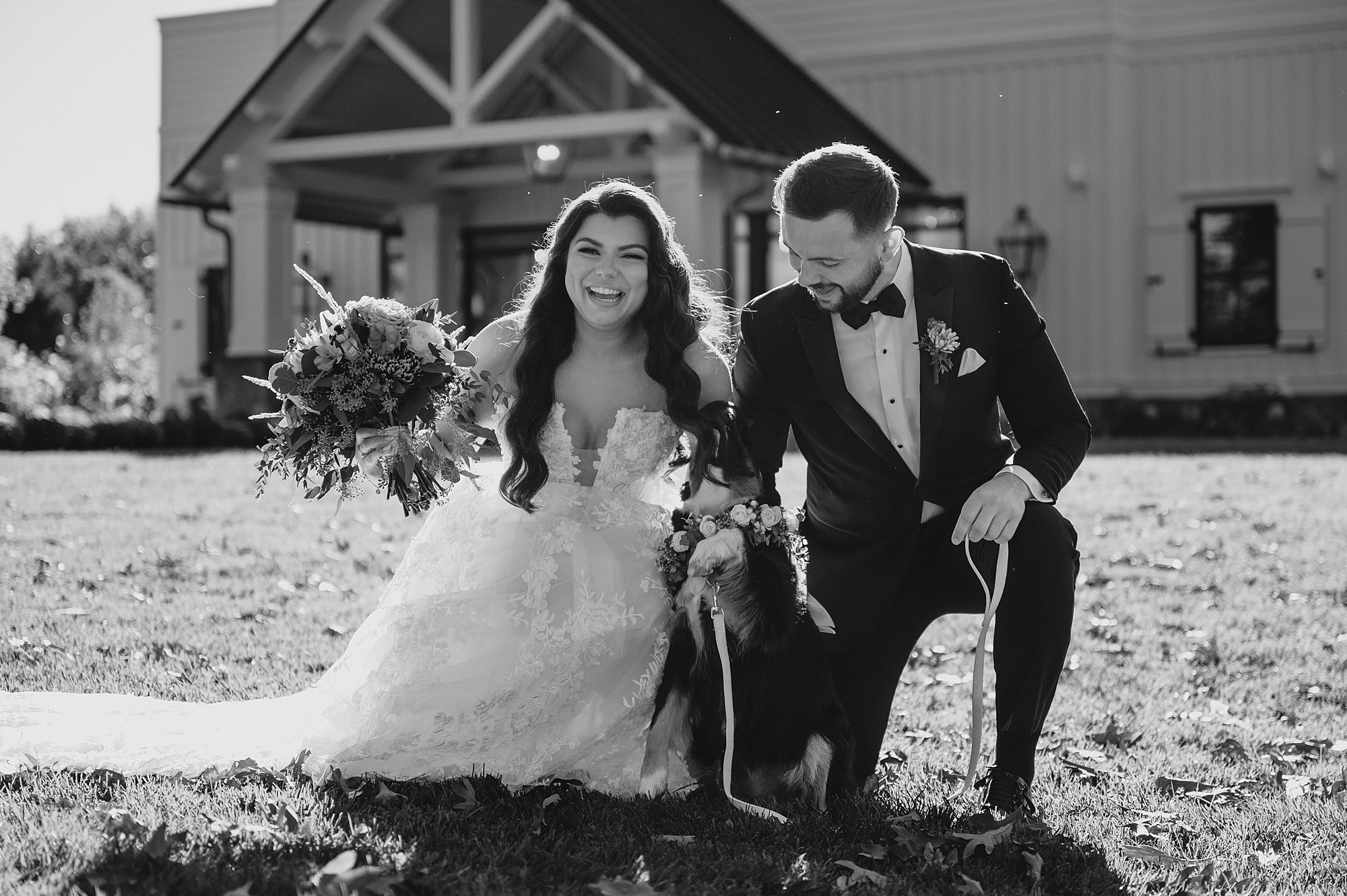 bride and groom kneel with dog standing outside Crossed Keys Estate