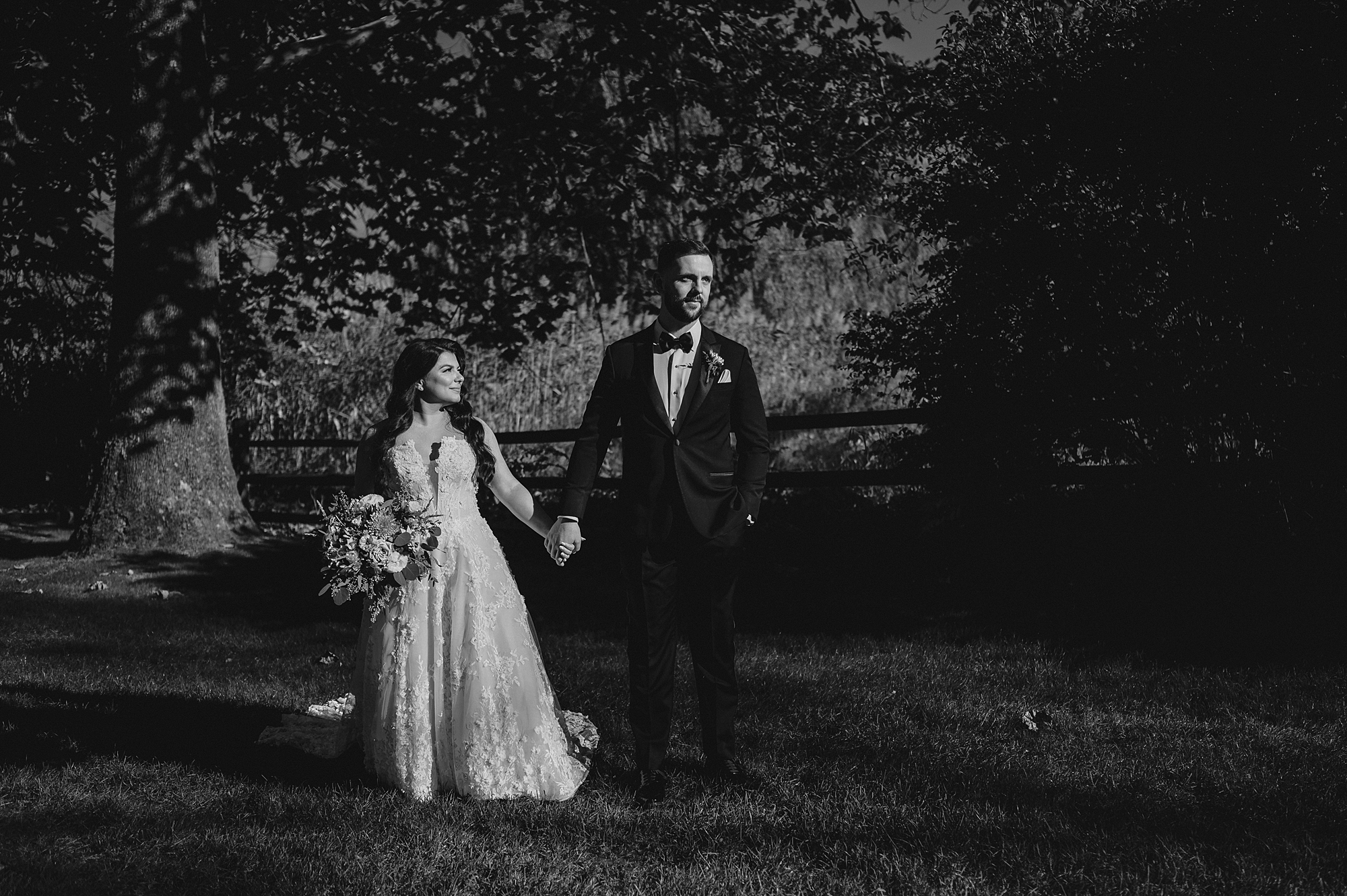 newlyweds walk across lawn at Crossed Keys Estate
