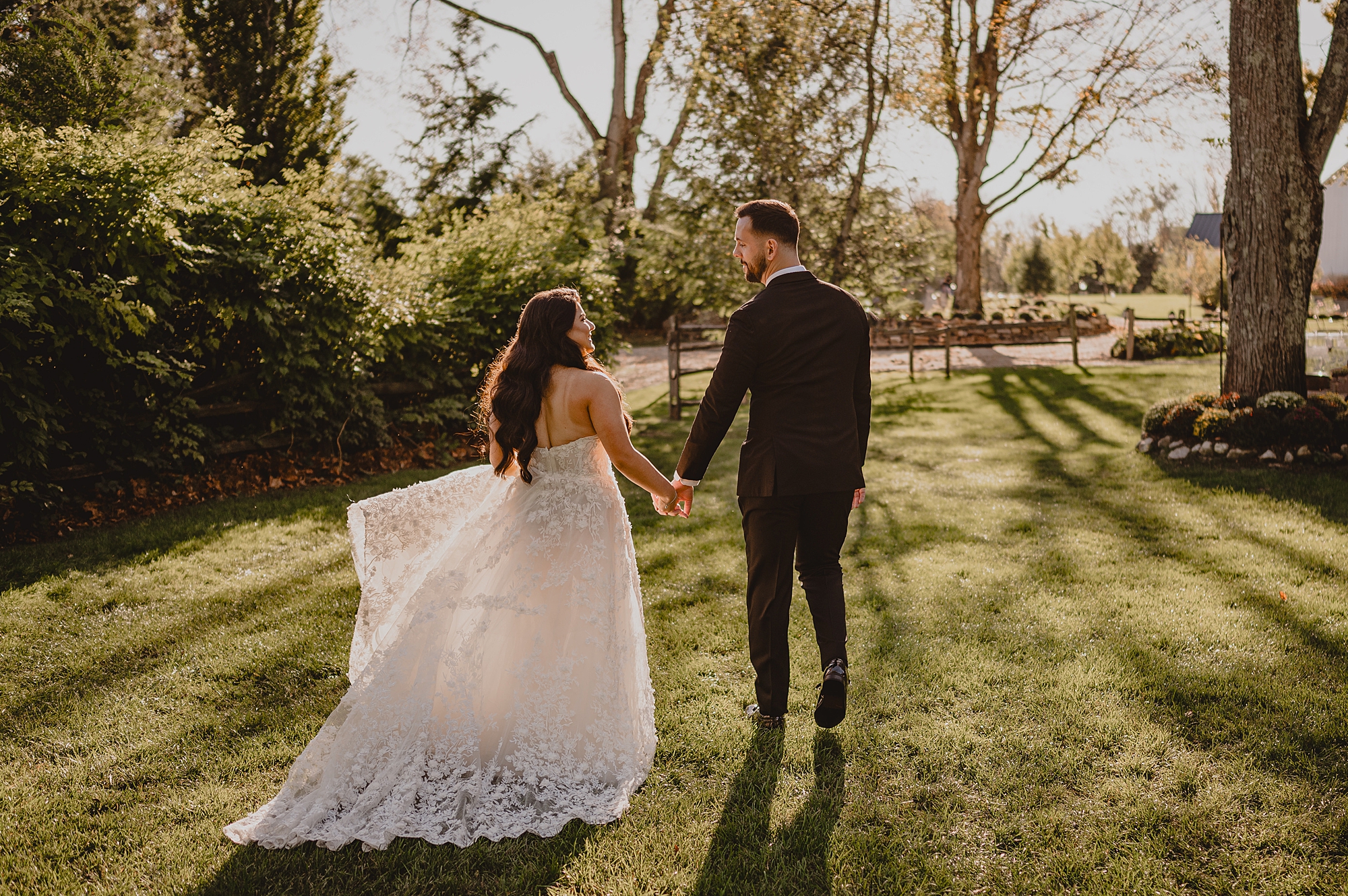 bride and groom walk towards gardens at Crossed Keys Estate