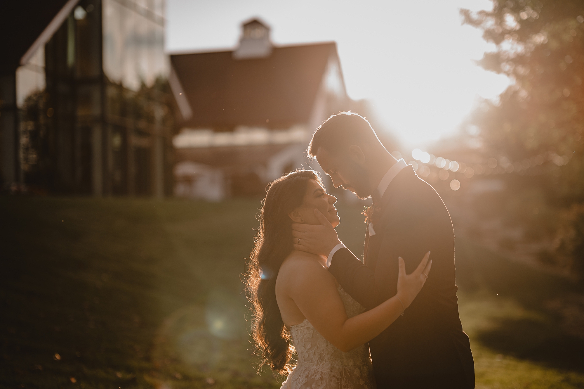 bride and groom hug leaning together at sunset outside Crossed Keys Estate