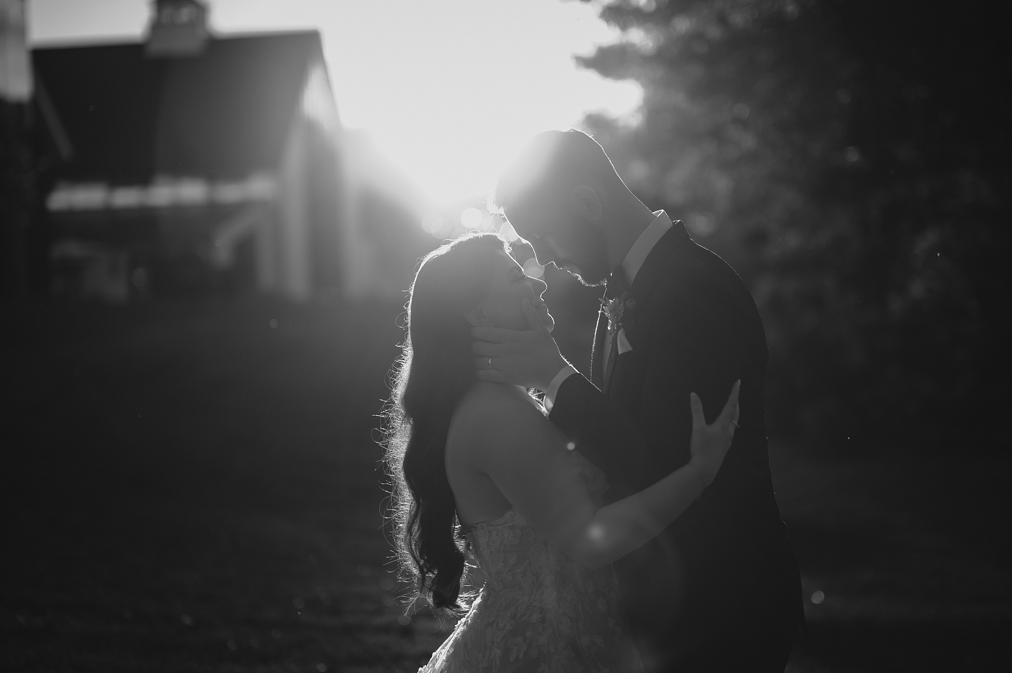bride and groom hug leaning heads together at sunset