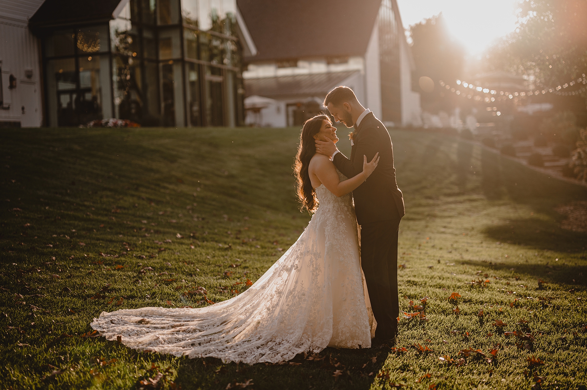 newlyweds hug on lawn at Crossed Keys Estate