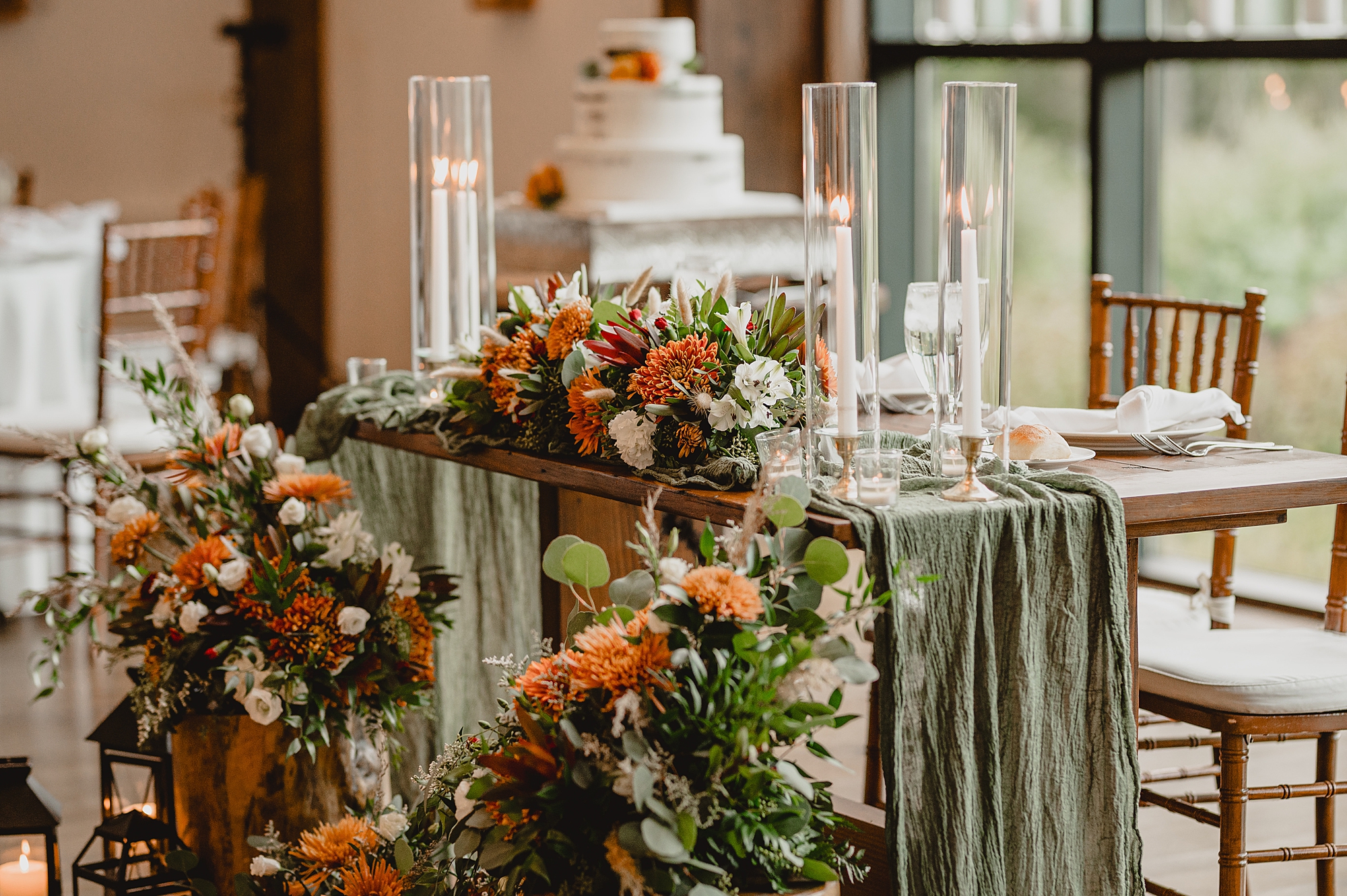 tied wedding cake on table with green fabric down sides
