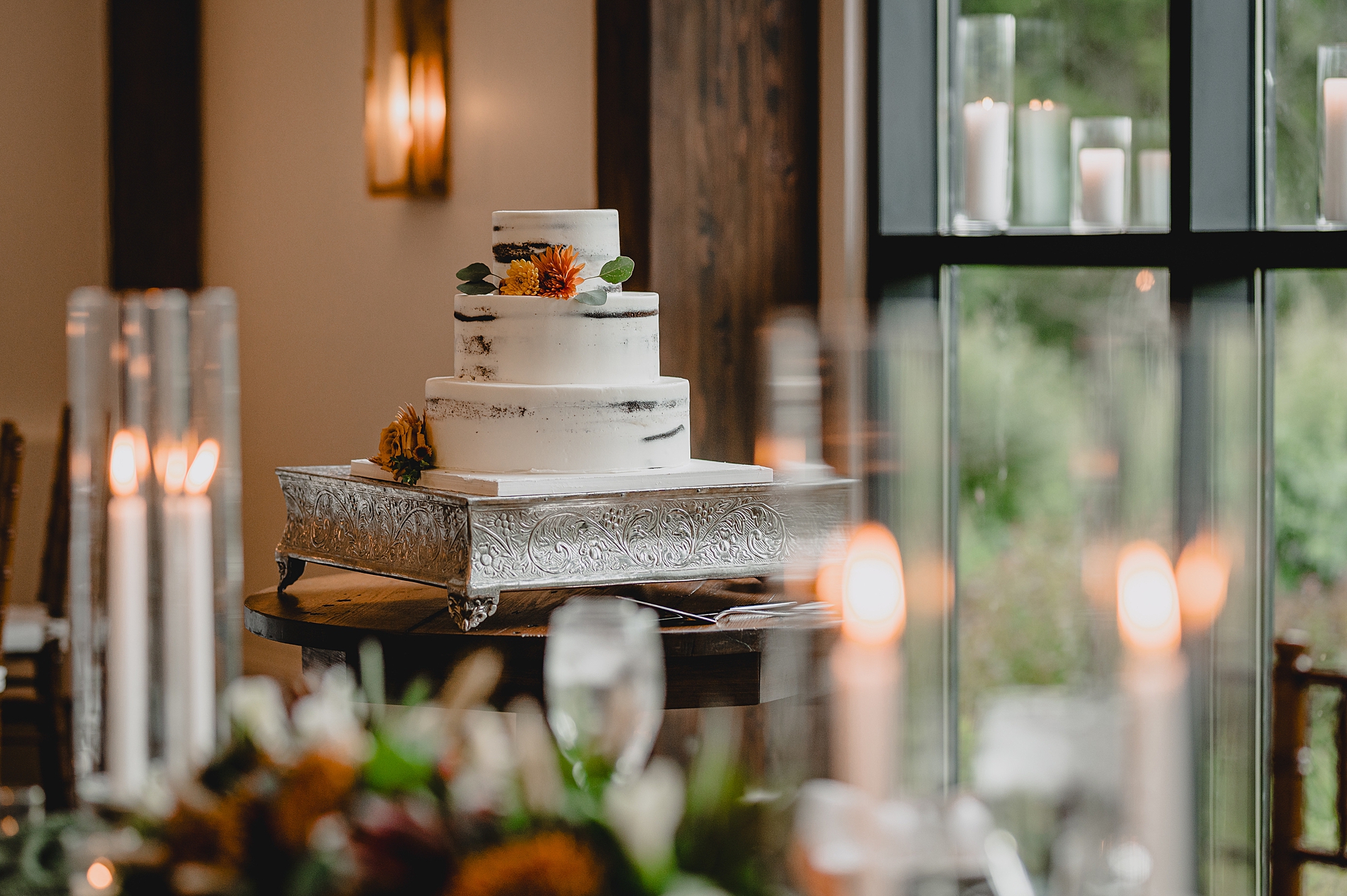 tiered wedding cake with orange flowers