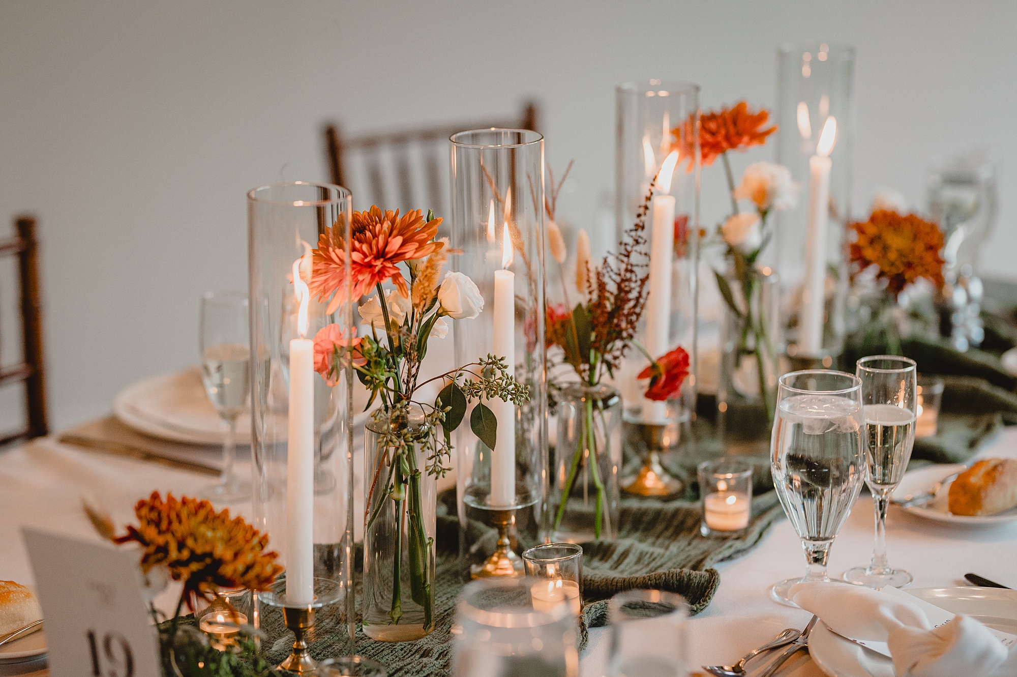 orange wildflowers line table at Crossed Keys Estate wedding reception