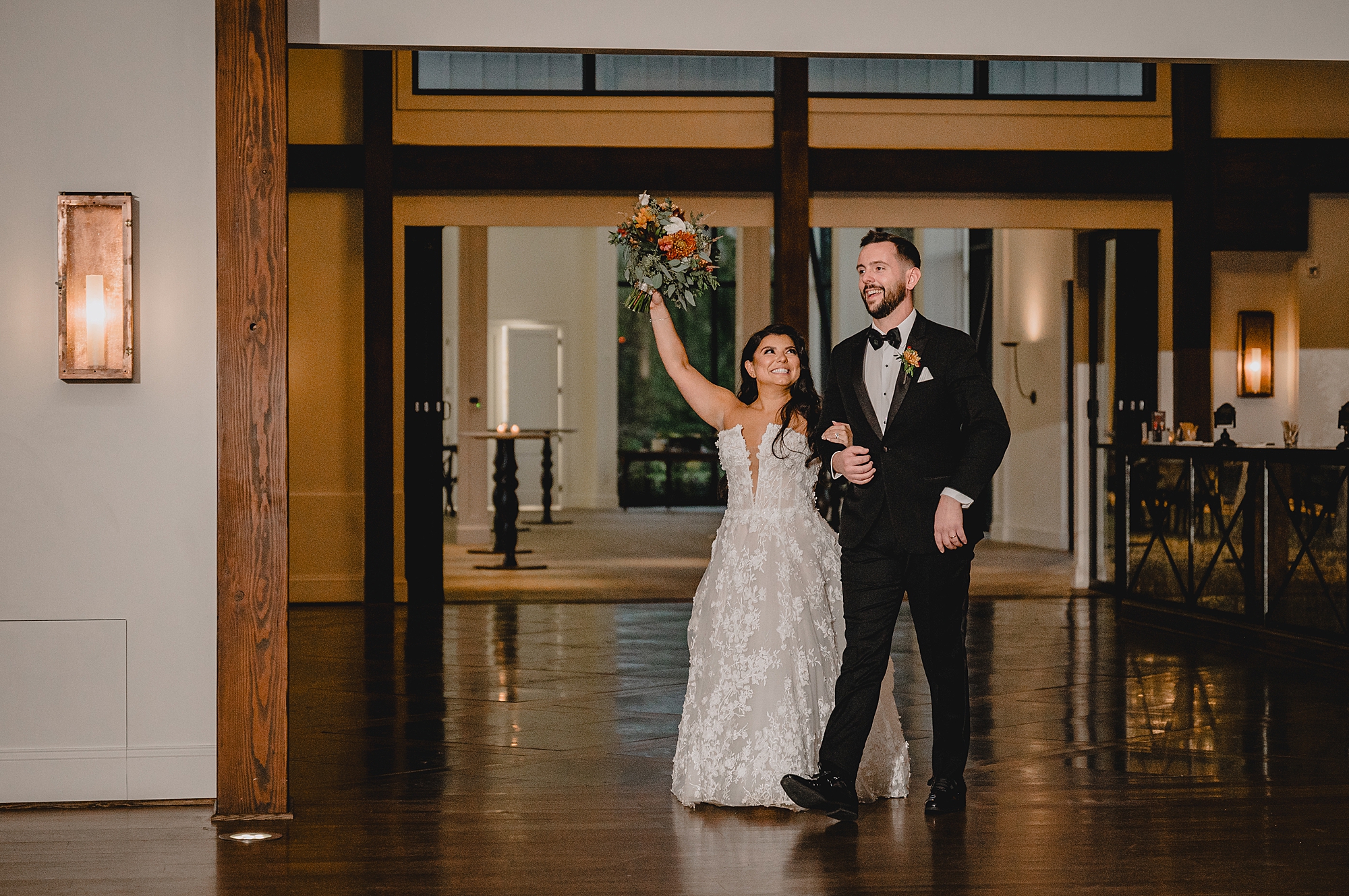 newlyweds cheer entering Andover NJ wedding reception at Crossed Keys Estate