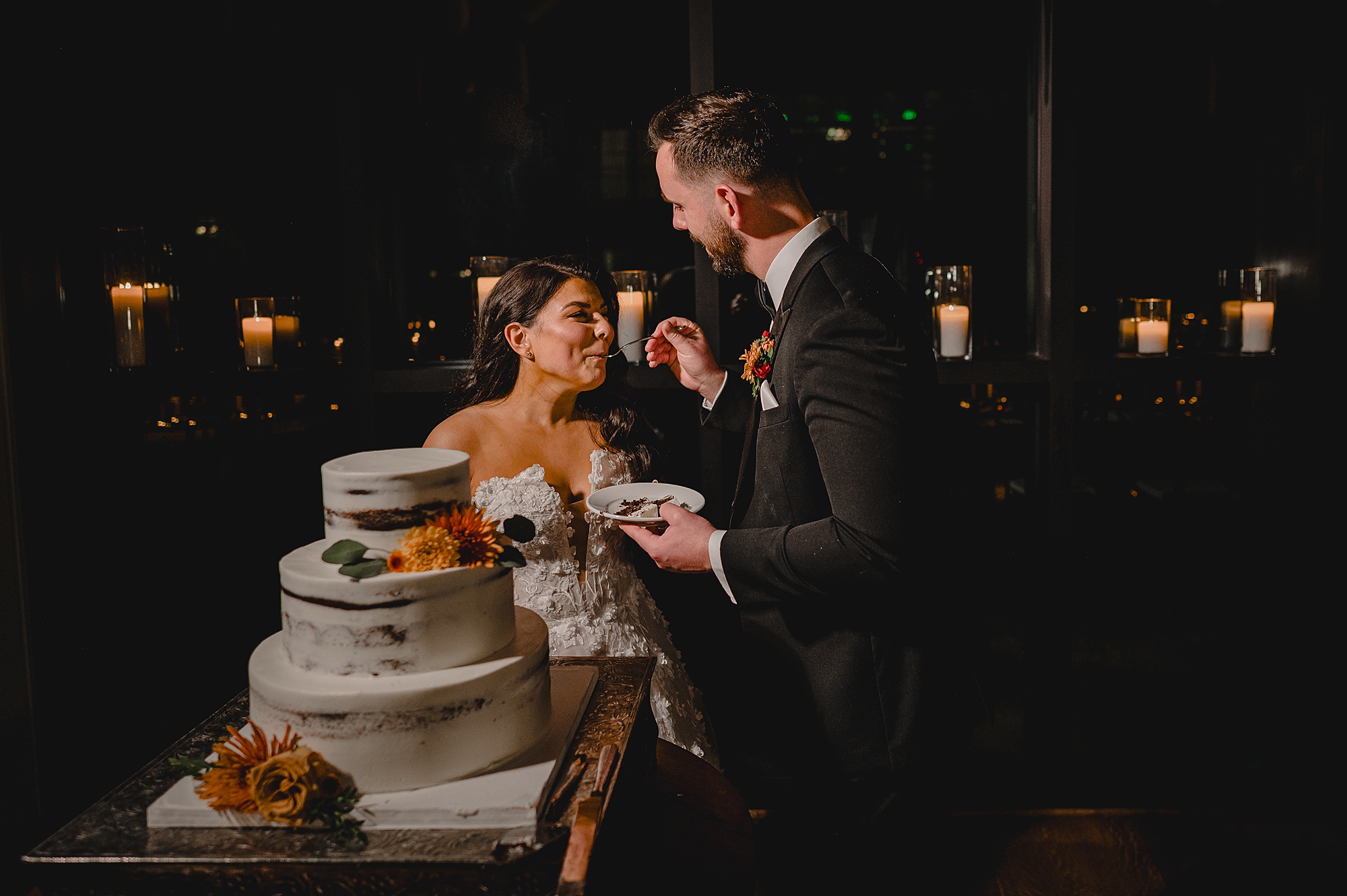 groom feeds bride slice of cake at Andover NJ wedding reception