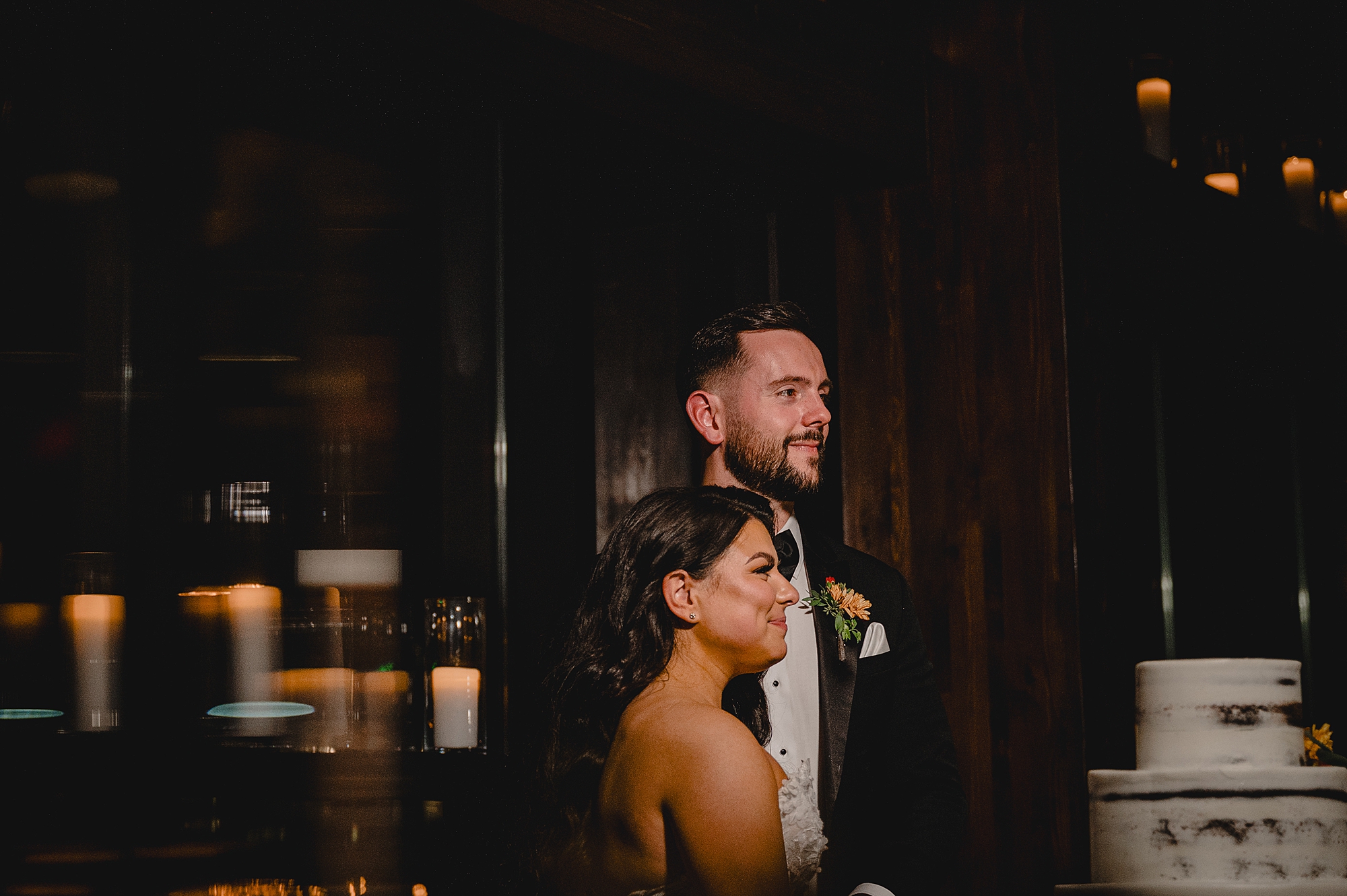 bride and groom smile in dark hallway at Andover NJ wedding reception