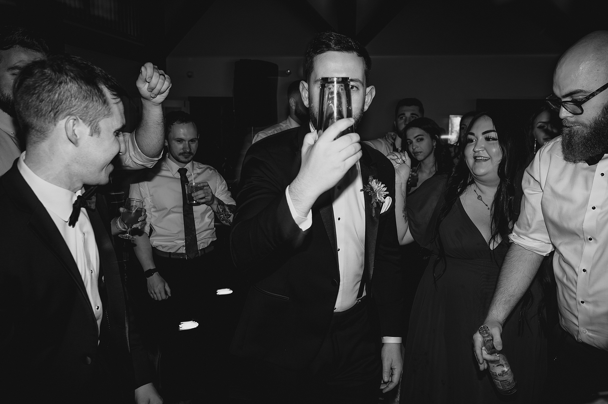 man dances with glasses in front of his face during Andover NJ wedding reception