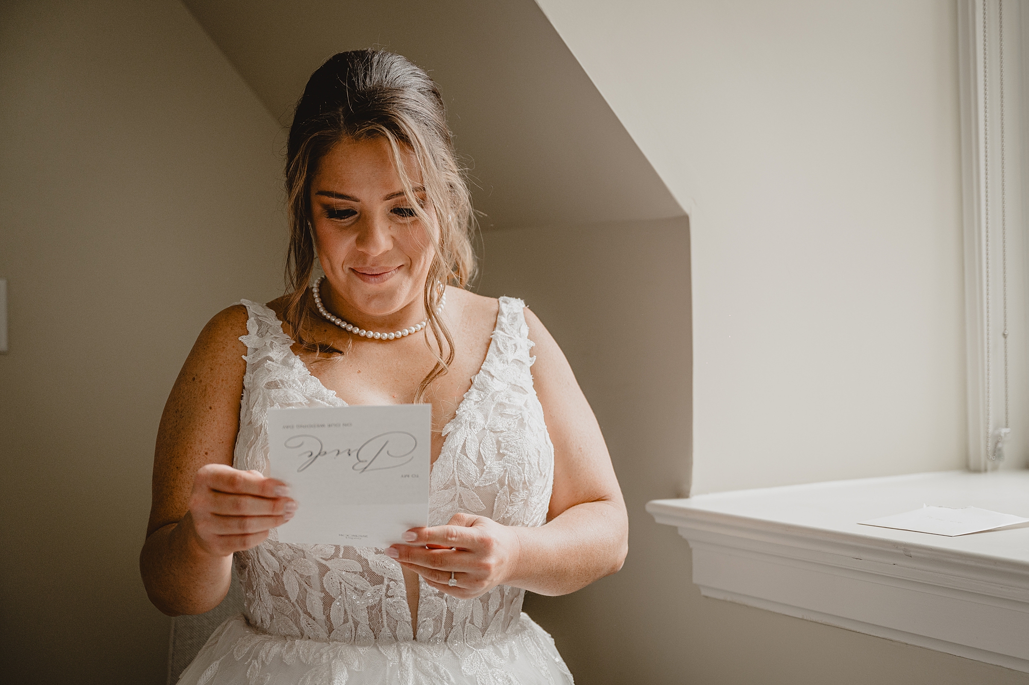 bride reads letter during wedding day in New York 